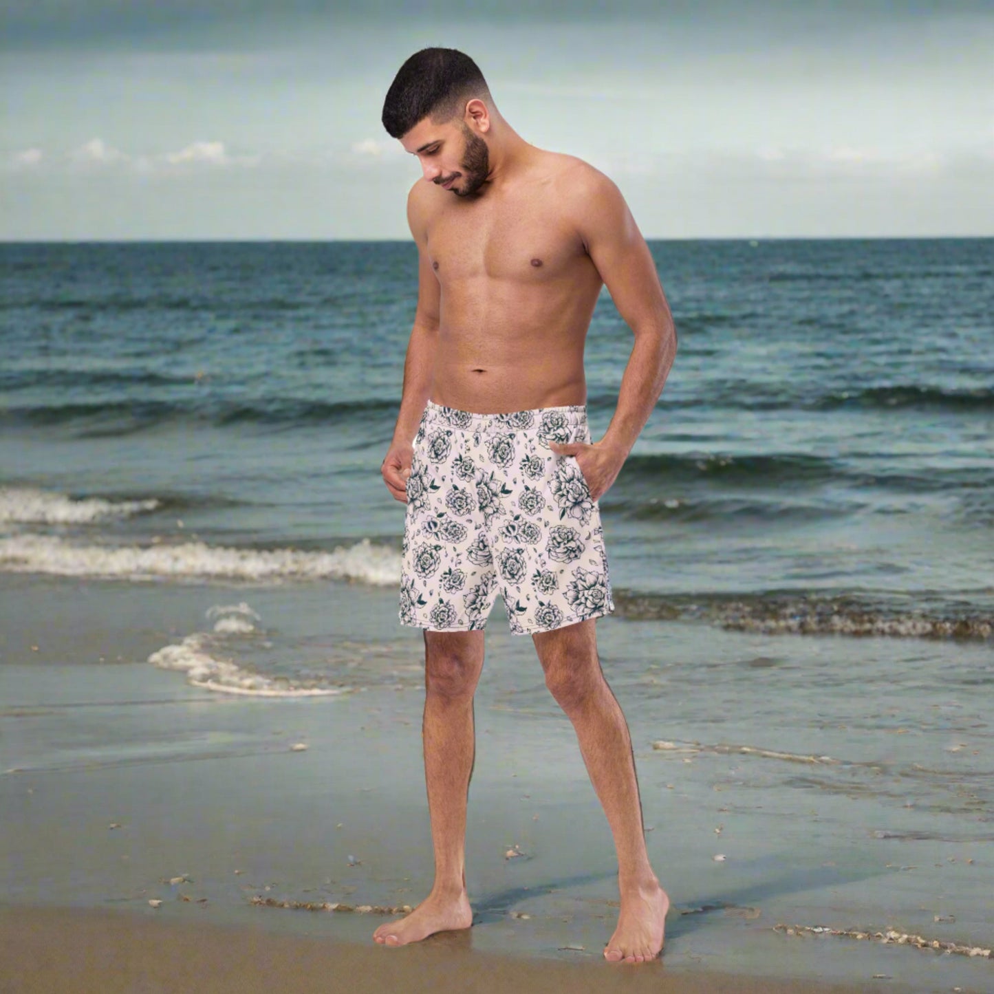 Make waves in our Pink Tattoo Roses Men’s Swim Trunks, featuring a black tattoo rose pattern on bold pink fabric. Made from 91% recycled polyester and built for comfort with an anti-chafe liner, mesh pockets, and UPF 50+ sun protection. These stylish and sustainable trunks are perfect for beach days, summer vacations, or matching family outfits. A must-have for dads and guys who want to combine bold fashion with eco-friendly swimwear.