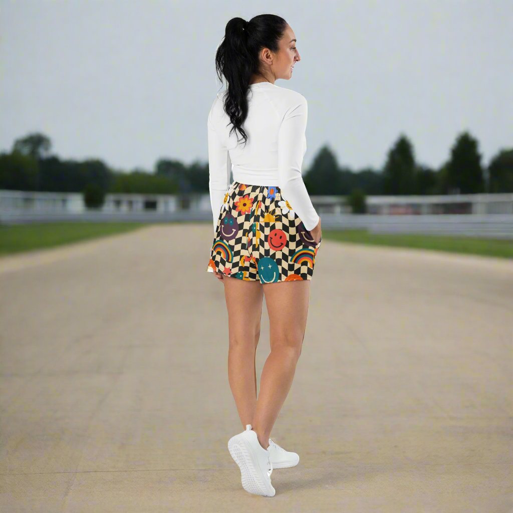 Smiley Face Checkerboard Ladies Athletic Shorts. These cute shorts feature a black and khaki checkerboard background, with smiley face, rainbow and daisy graphics. by jaecrece.com