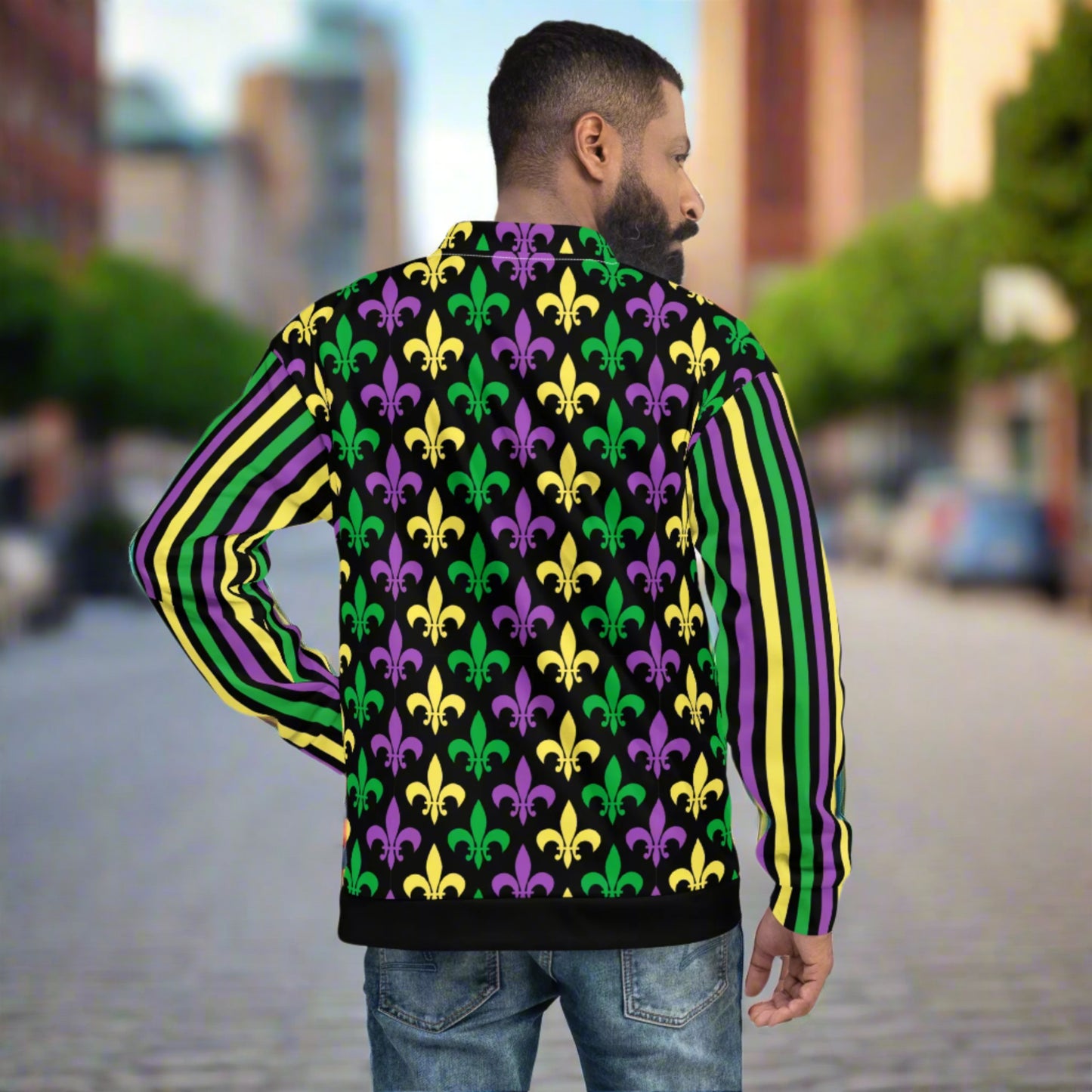 Image: Mardi Gras Unisex Bomber Jacket. This lightweight NOLA apparel is perfect for parades in the French Quarter, or Mardi Gras themed fun runs. It features a gold, green and purple fleur de lis pattern on the front and back, with gold, purple and green stripes going down each arm. Plus sizes available, by jaecrece