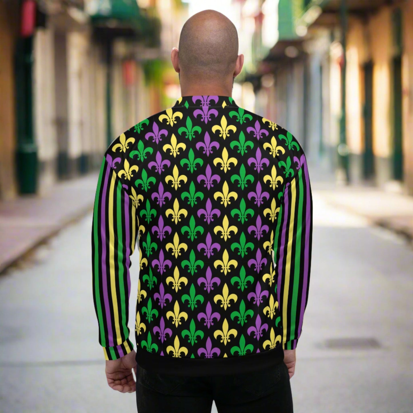 Image: Mardi Gras Unisex Bomber Jacket. This lightweight NOLA apparel is perfect for parades in the French Quarter, or Mardi Gras themed fun runs. It features a gold, green and purple fleur de lis pattern on the front and back, with gold, purple and green stripes going down each arm. Plus sizes available, by jaecrece
