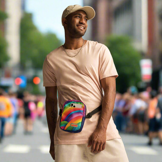 Alt Text: Man wearing a rainbow crossbody bag that reads LOVE in text
