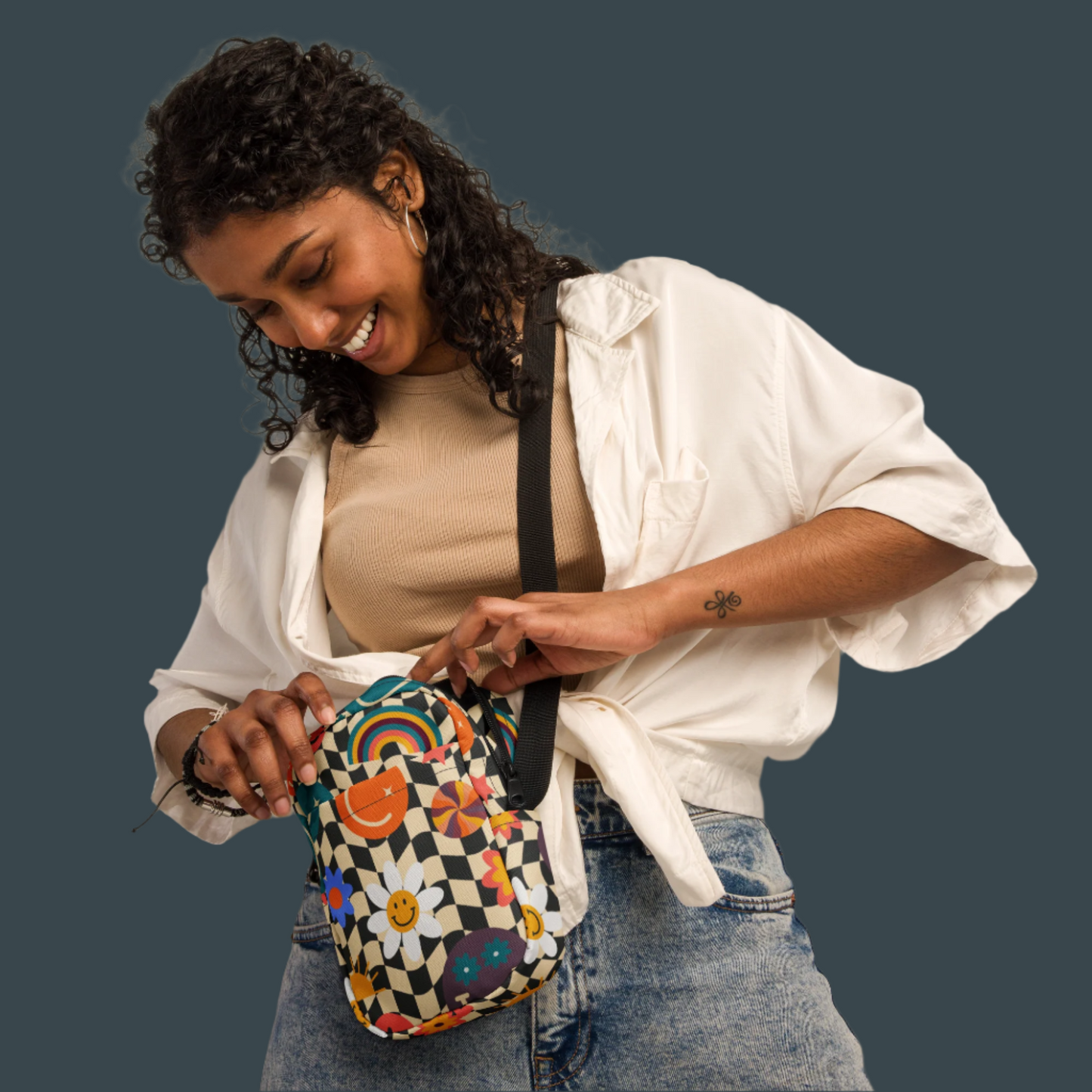 Image: With its cute rainbow smiley and retro checkerboard print, this mini canvas bag adds a splash of joy to any outfit. Whether used as a small crossbody for everyday adventures or a camera pouch for vacations, this purse fits the vibe of teens, tweens, and women who love vintage trends. It makes a perfect Christmas gift, birthday surprise, or stocking stuffer idea for someone stylish, by jaecrece.