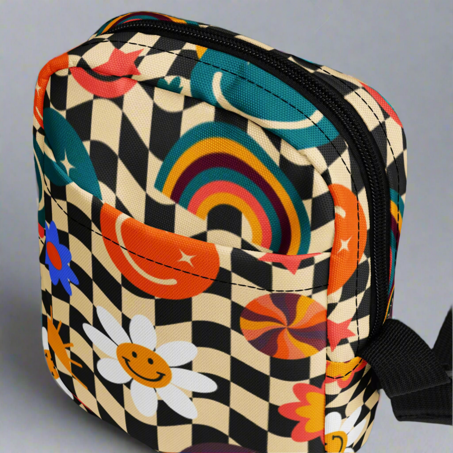 Image: A retro checkerboard sling bag designed for girls and tweens, this smiley face crossbody is a fun mix of fashion and function. Made from durable canvas, it is lightweight with roomy compartments for all the daily must haves. Perfect as a gift for her, this cute summer accessory doubles as a small camera purse or fall fashion staple for back to school or casual outings, by jaecrece.