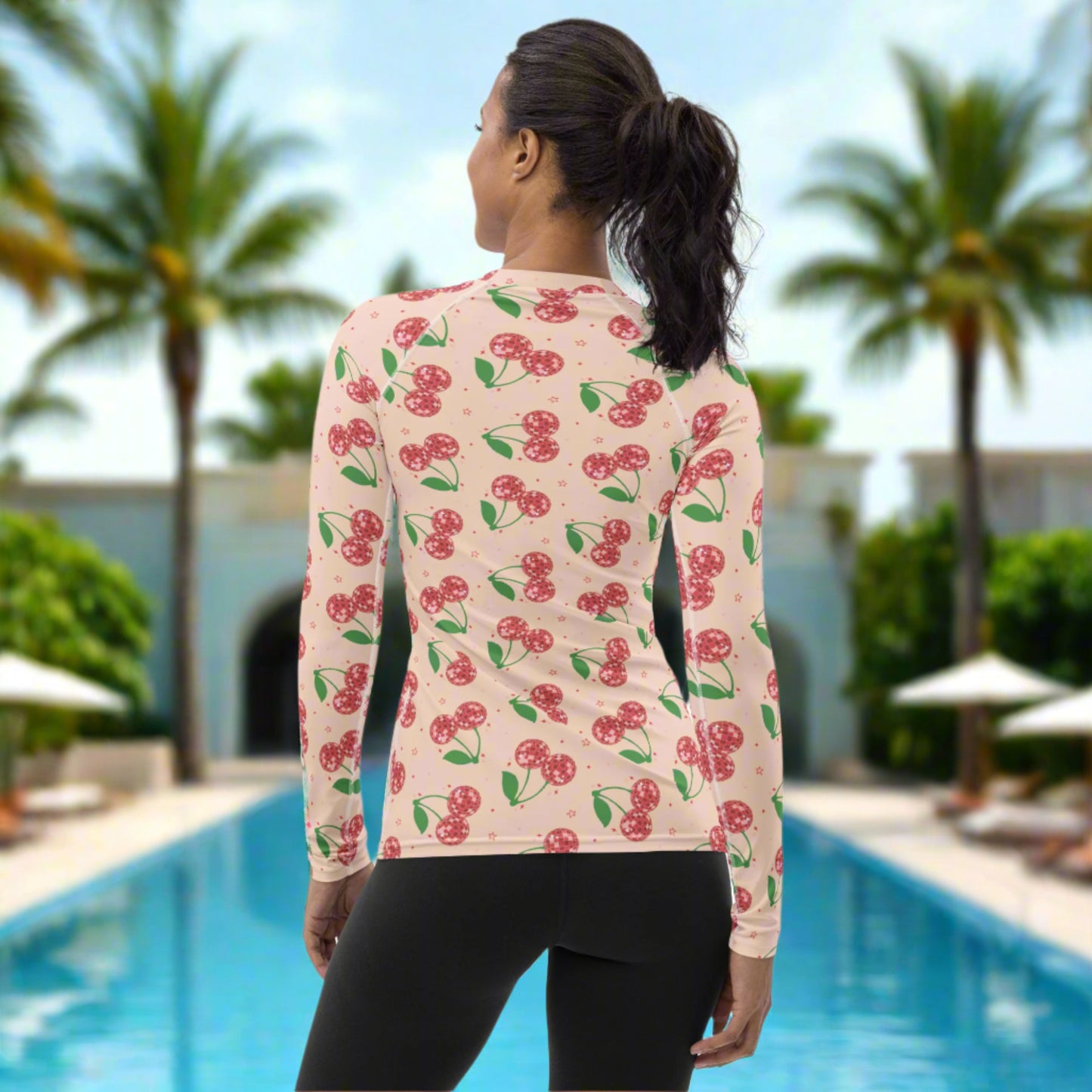 Image: Retro Cherries Womens Rash Guard. This fruit inspired swimwear is a part of our Family Matching Swimwear Collection, and features a pink background with red disco ball cherries and stars, by jaecrece