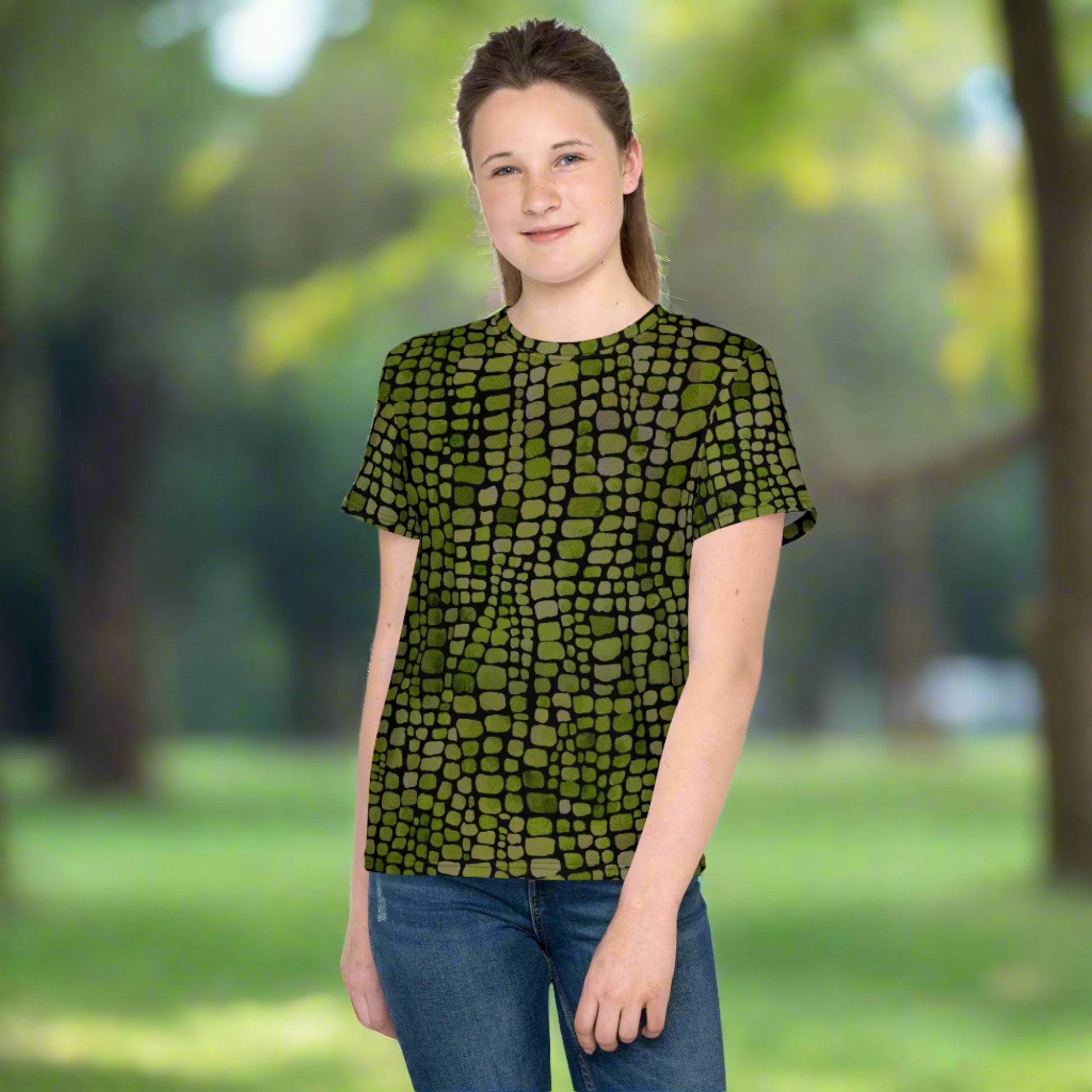 Youth dinosaur costume shirt with green reptile print, available in sizes 8–20. Whether for a snake costume, lizard look, or wild summer tee, this shirt brings scale-inspired style to everyday outfits. Breathable fabric ensures comfort while the vivid pattern inspires jungle adventure and dress-up fun. Great for themed parties, school days, and active outdoor kids who love reptiles.