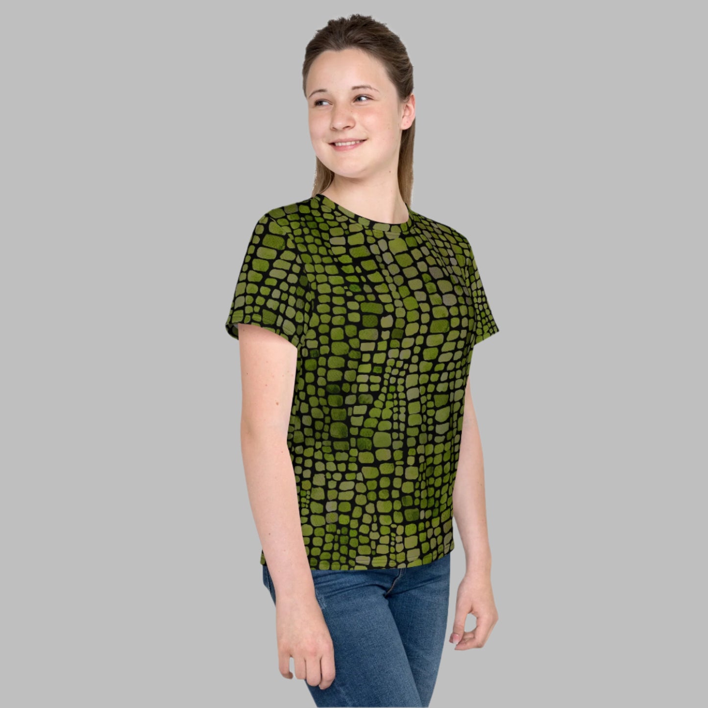Kids green reptile pattern t-shirt in youth sizes 8–20. Featuring all-over scales, this shirt is perfect for lizard or dinosaur costumes, jungle dress-up fun, or just everyday reptile style. A bold choice for boys and girls who love wild creatures, nature, and statement fashion. Great for school outfits, parties, or summer activities, with soft fabric and a standout print that inspires imagination.