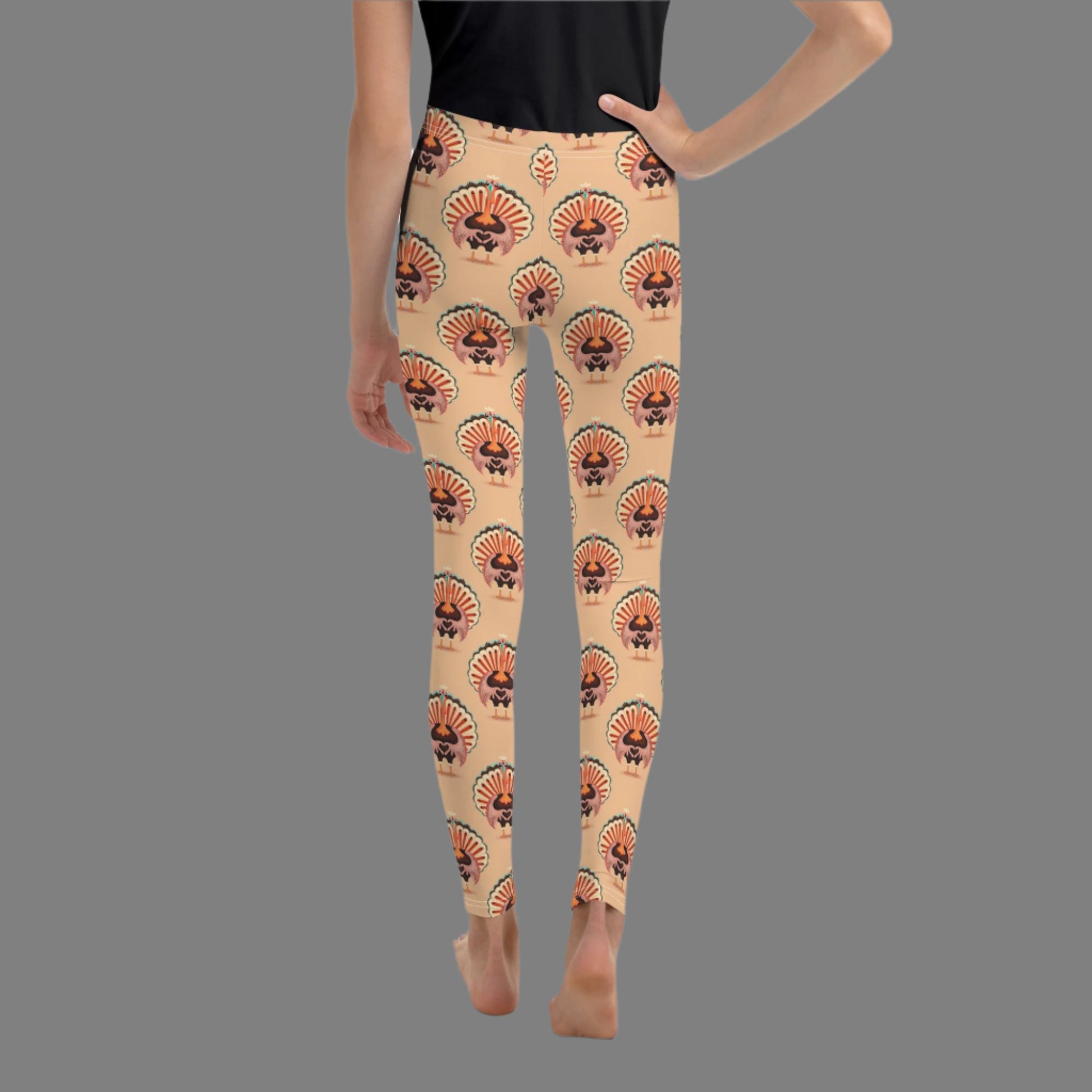 Thanksgiving Turkey Love child leggings. These girls yoga pants are peach, and have a repeating pattern of turkeys showing the love sign with their hands. These girls child tights make a great gift, or a family matching outfit for the Turkey Trot! by jaecrece