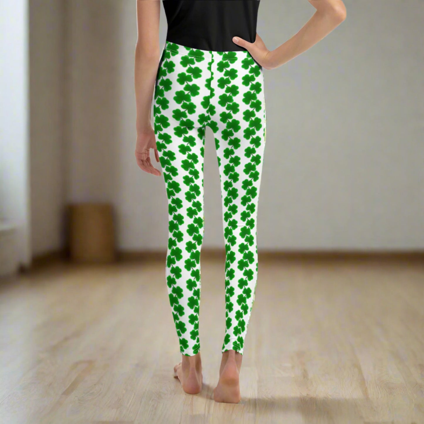 Image: St Patricks Day Shamrock Leggings in Tween and Teen Girls Sizes 8, 10, 12, 14, 16, 18, 20. These white yoga pants feature rows of four leaf clovers in a pattern down each leg, by jaecrece