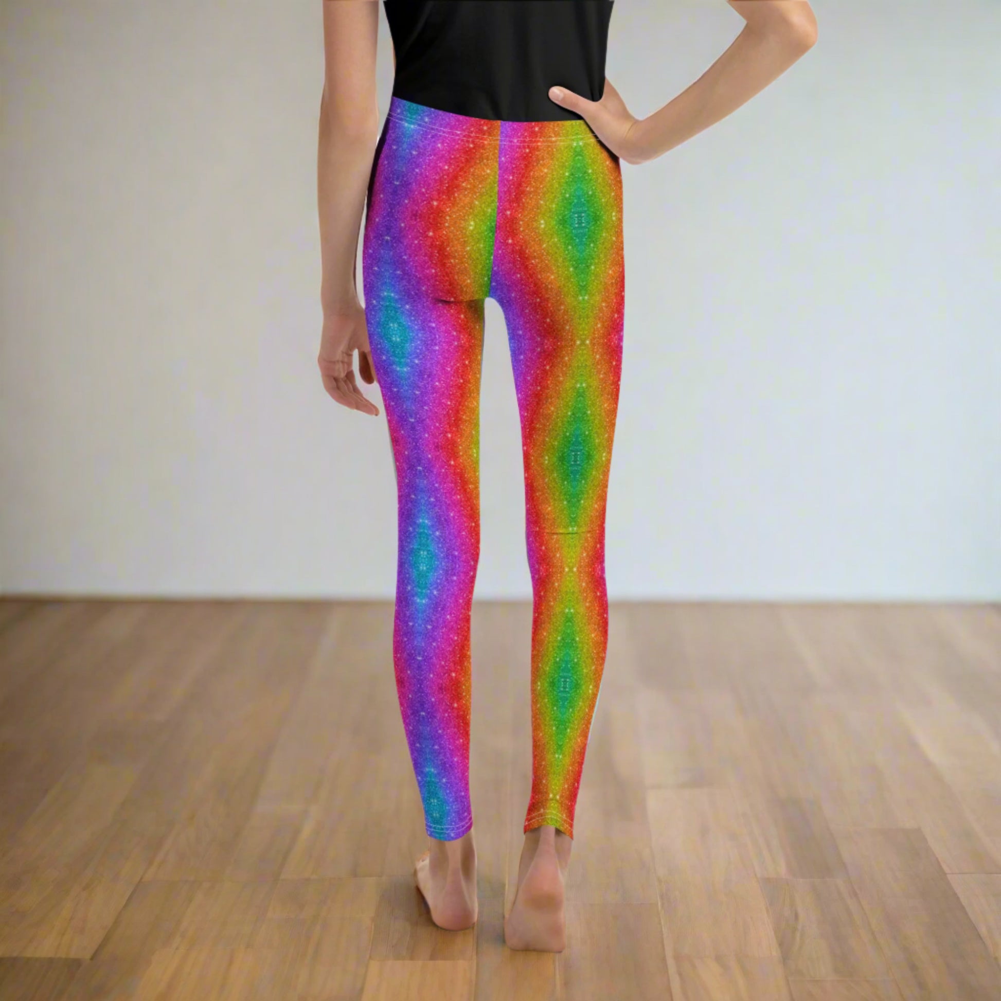 Rainbow glitter swirl leggings for girls sizes 8–20—great for dance practice, festival wear, or matching with mom and siblings. These vibrant leggings feature a faux glitter effect in a holographic rainbow swirl, adding a pop of bold color to any outfit. With stretch and comfort built in, they’re perfect for active tweens who love bright, eye-catching fashion.