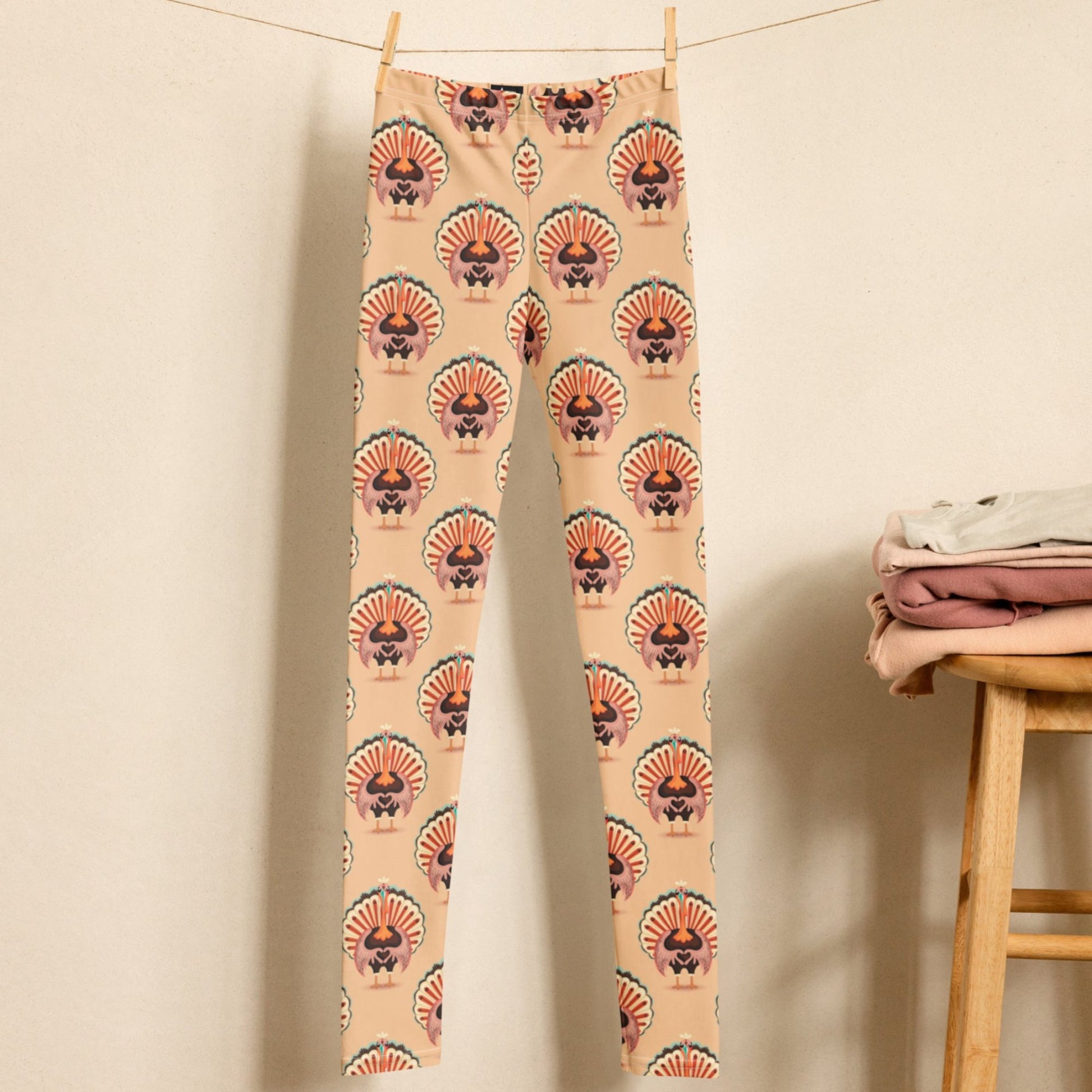 Thanksgiving Turkey Love child leggings. These girls yoga pants are peach, and have a repeating pattern of turkeys showing the love sign with their hands. These girls child tights make a great gift, or a family matching outfit for the Turkey Trot! by jaecrece