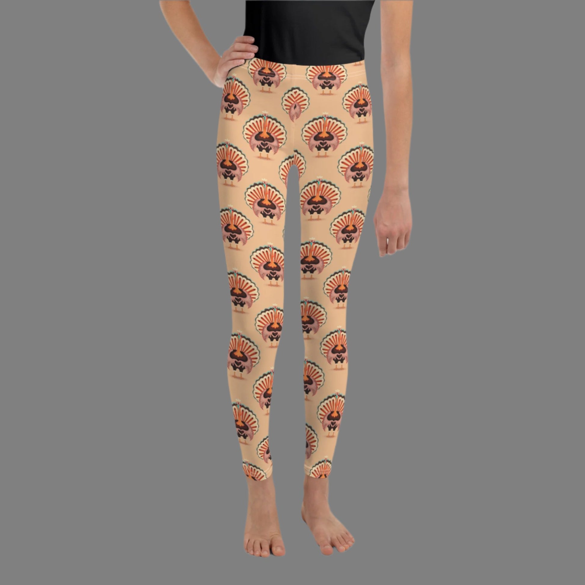 Thanksgiving Turkey Love child leggings. These girls yoga pants are peach, and have a repeating pattern of turkeys showing the love sign with their hands. These girls child tights make a great gift, or a family matching outfit for the Turkey Trot! by jaecrece