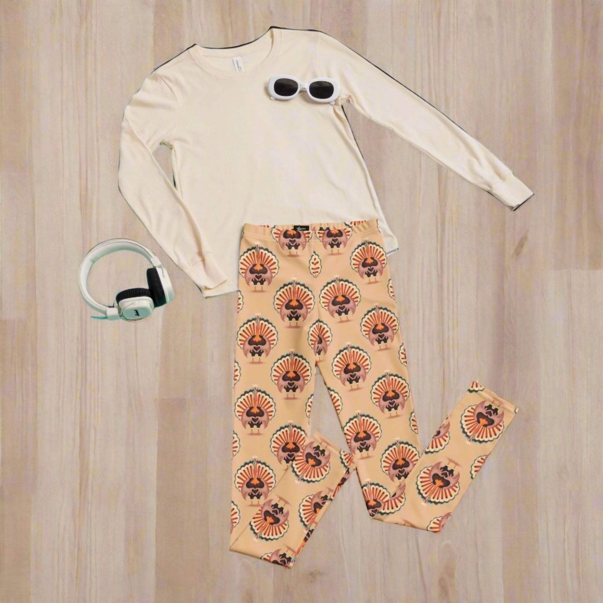 Thanksgiving Turkey Love child leggings. These girls yoga pants are peach, and have a repeating pattern of turkeys showing the love sign with their hands. These girls child tights make a great gift, or a family matching outfit for the Turkey Trot! by jaecrece