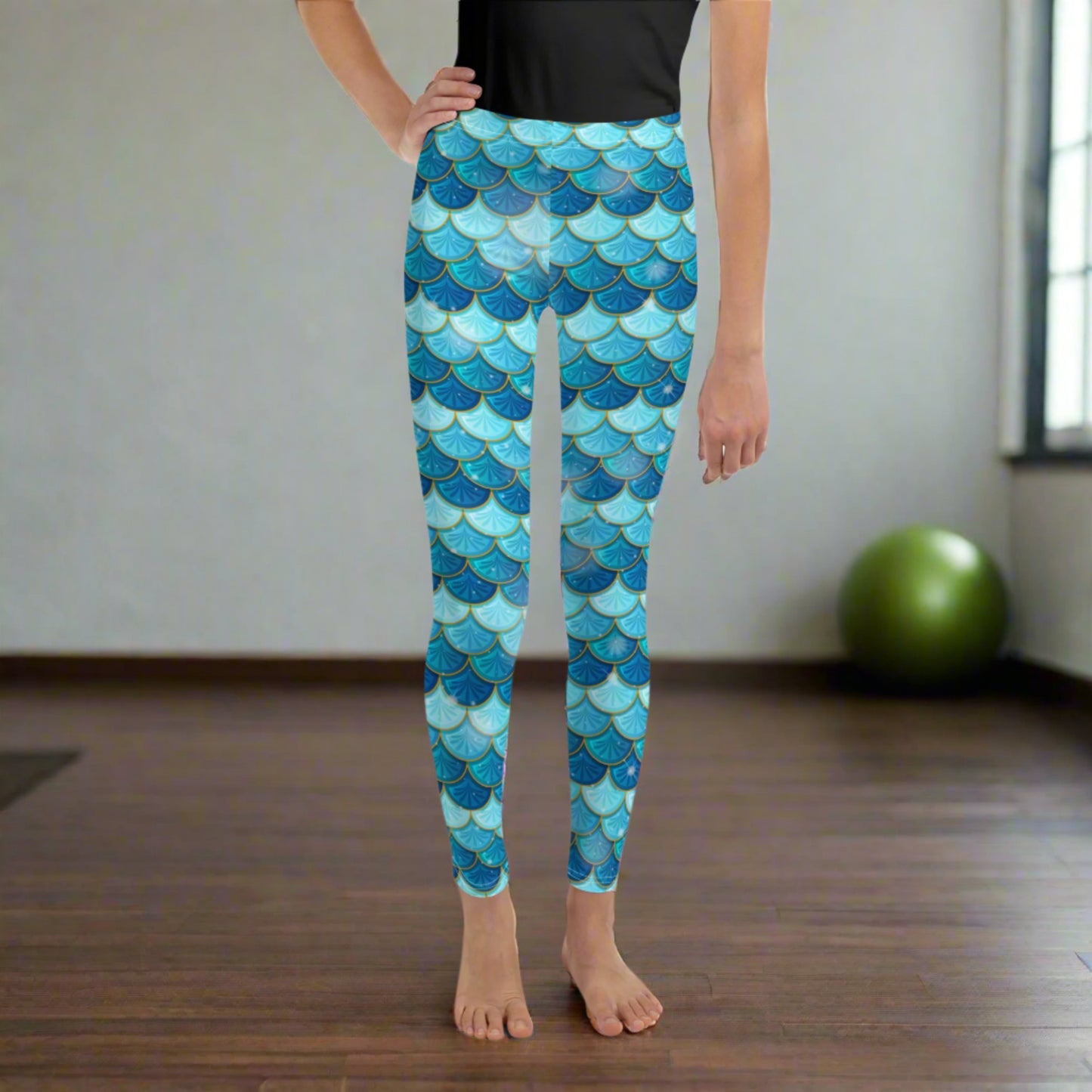 Image: Mermaid Youth Girls Leggings feature a stunning blue scale print, perfect for tweens and teens in sizes 8-20. Perfect for girls who love the mermaid aesthetic, by jaecrece