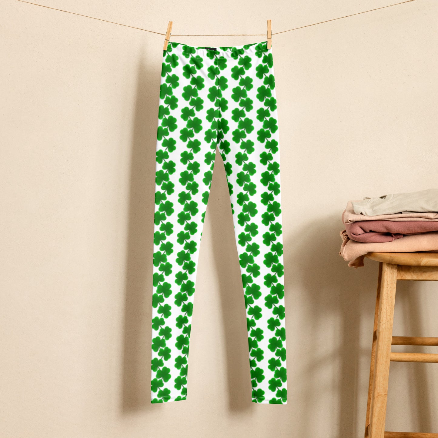 Image: St Patricks Day Shamrock Leggings in Tween and Teen Girls Sizes 8, 10, 12, 14, 16, 18, 20. These white yoga pants feature rows of four leaf clovers in a pattern down each leg, by jaecrece