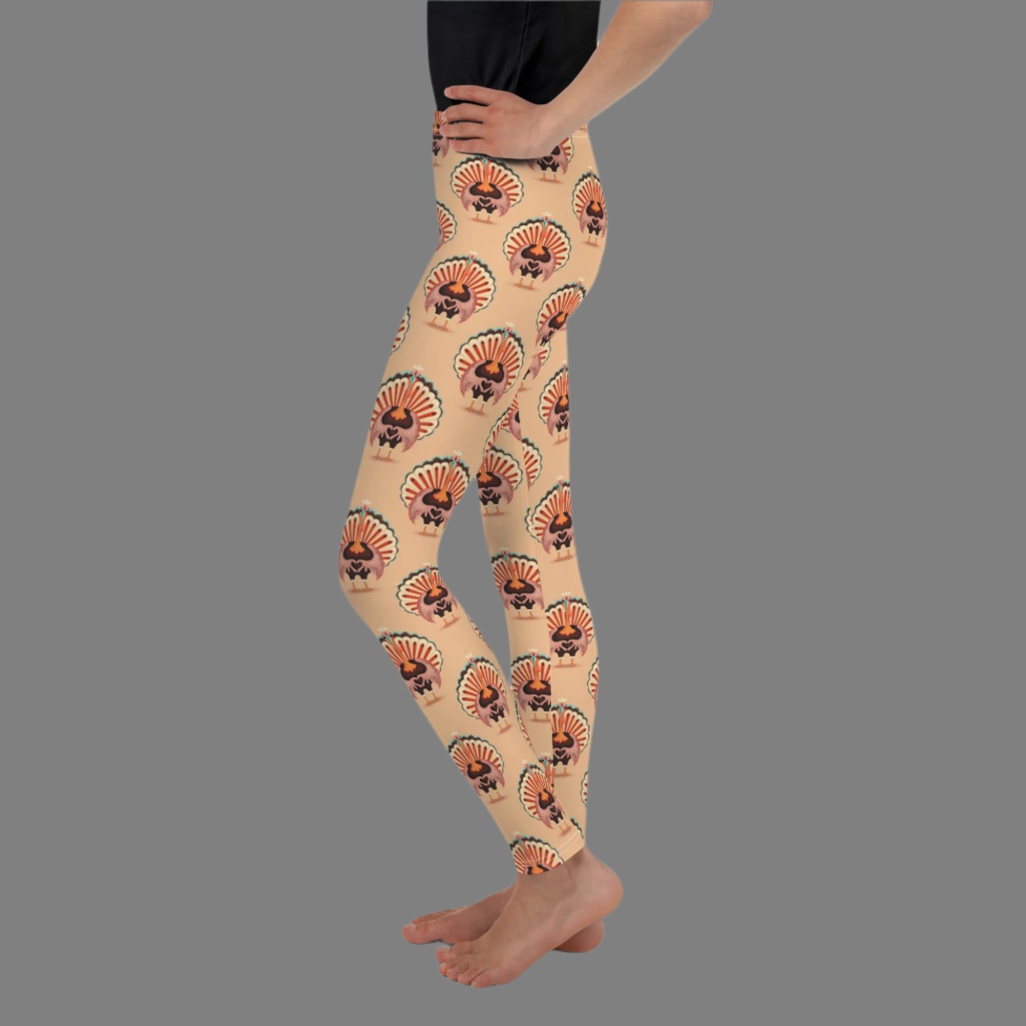Thanksgiving Turkey Love child leggings. These girls yoga pants are peach, and have a repeating pattern of turkeys showing the love sign with their hands. These girls child tights make a great gift, or a family matching outfit for the Turkey Trot! by jaecrece
