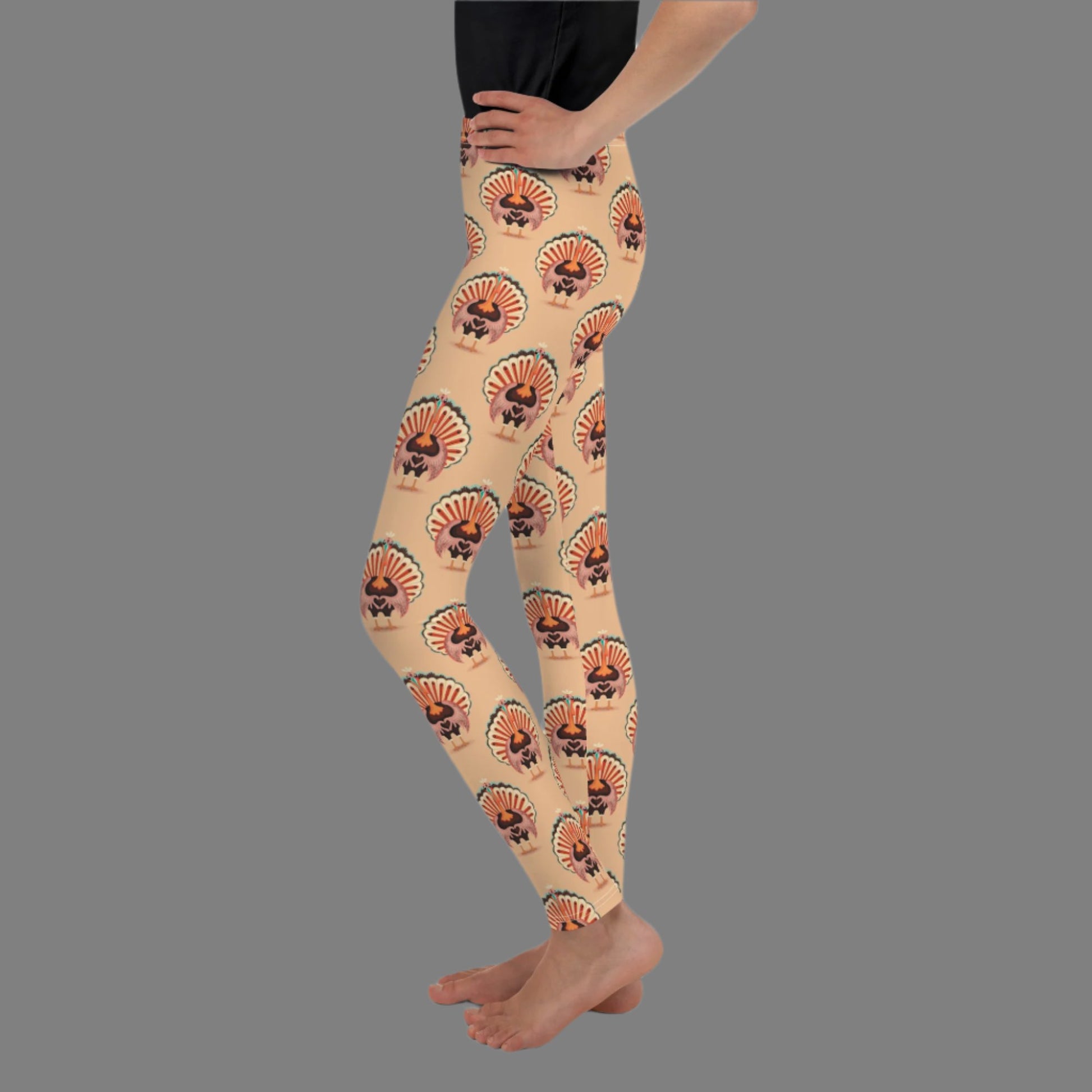 Thanksgiving Turkey Love child leggings. These girls yoga pants are peach, and have a repeating pattern of turkeys showing the love sign with their hands. These girls child tights make a great gift, or a family matching outfit for the Turkey Trot! by jaecrece