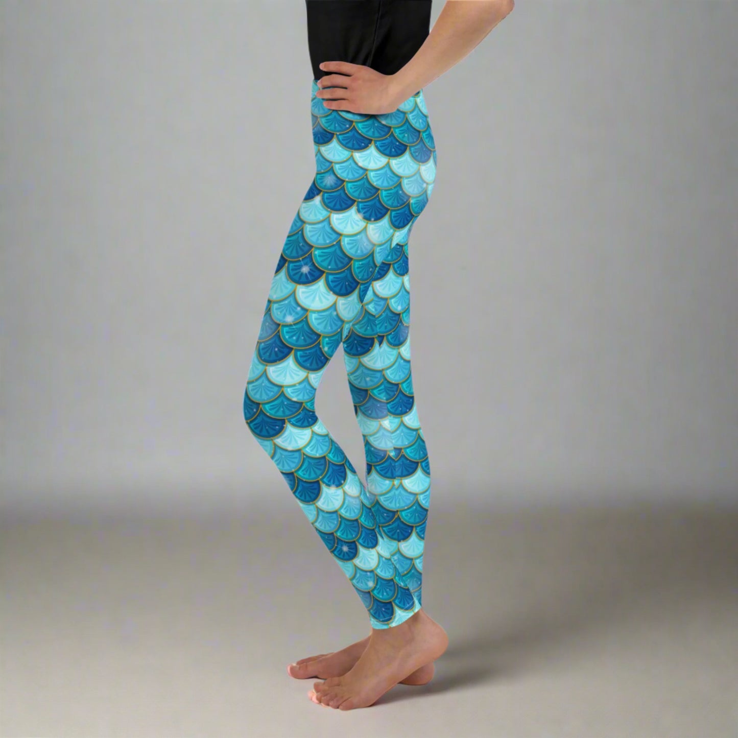 Image: Mermaid Youth Girls Leggings feature a stunning blue scale print, perfect for tweens and teens in sizes 8-20. Perfect for girls who love the mermaid aesthetic, by jaecrece