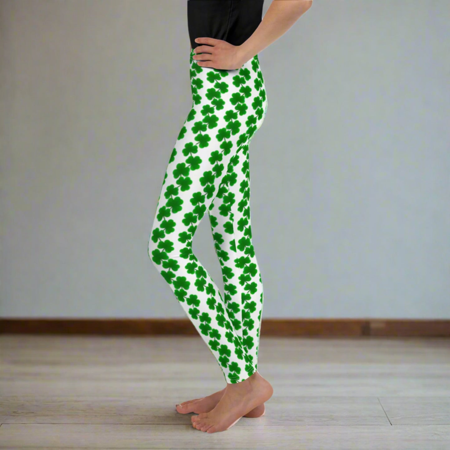 Image: St Patricks Day Shamrock Leggings in Tween and Teen Girls Sizes 8, 10, 12, 14, 16, 18, 20. These white yoga pants feature rows of four leaf clovers in a pattern down each leg, by jaecrece