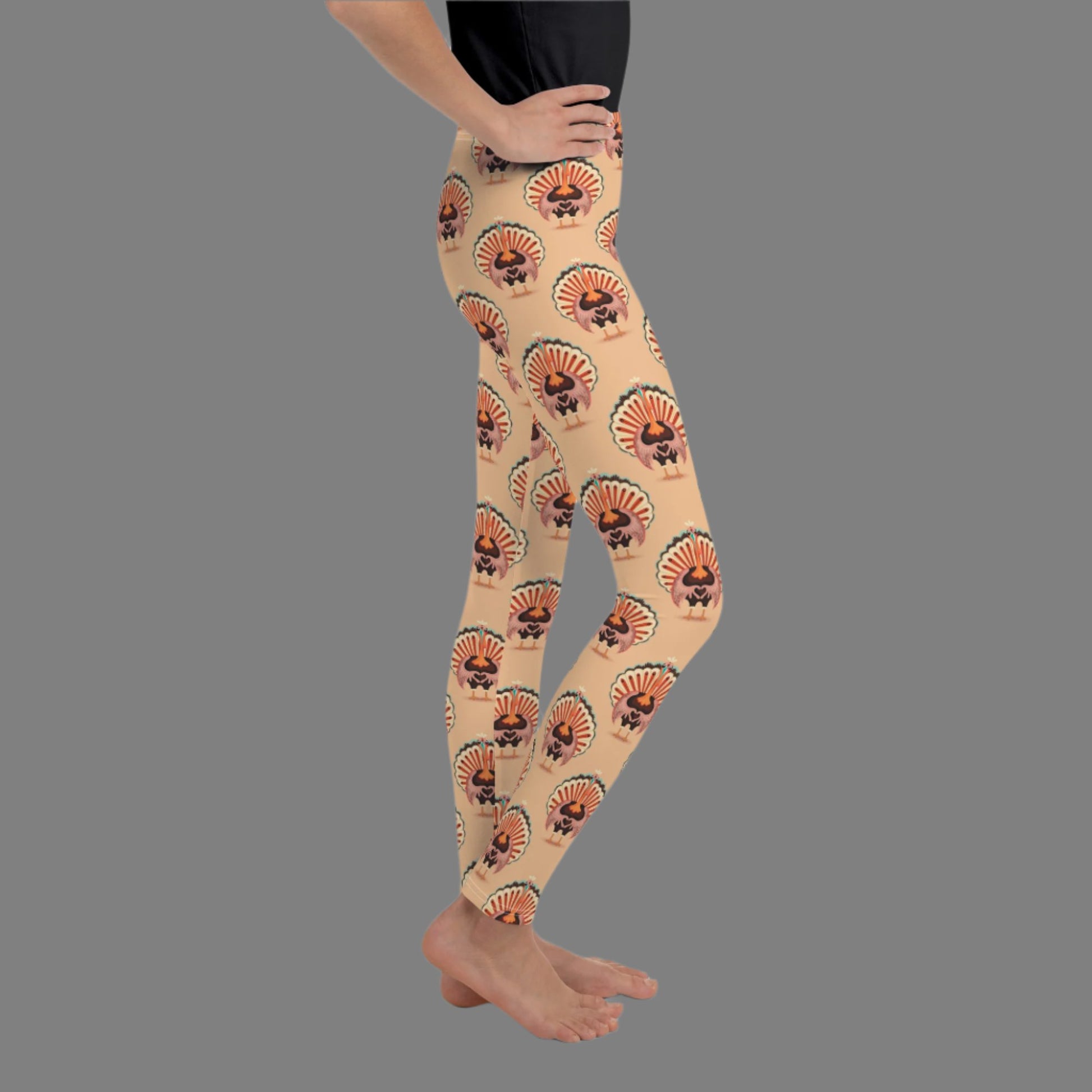 Thanksgiving Turkey Love child leggings. These girls yoga pants are peach, and have a repeating pattern of turkeys showing the love sign with their hands. These girls child tights make a great gift, or a family matching outfit for the Turkey Trot! by jaecrece