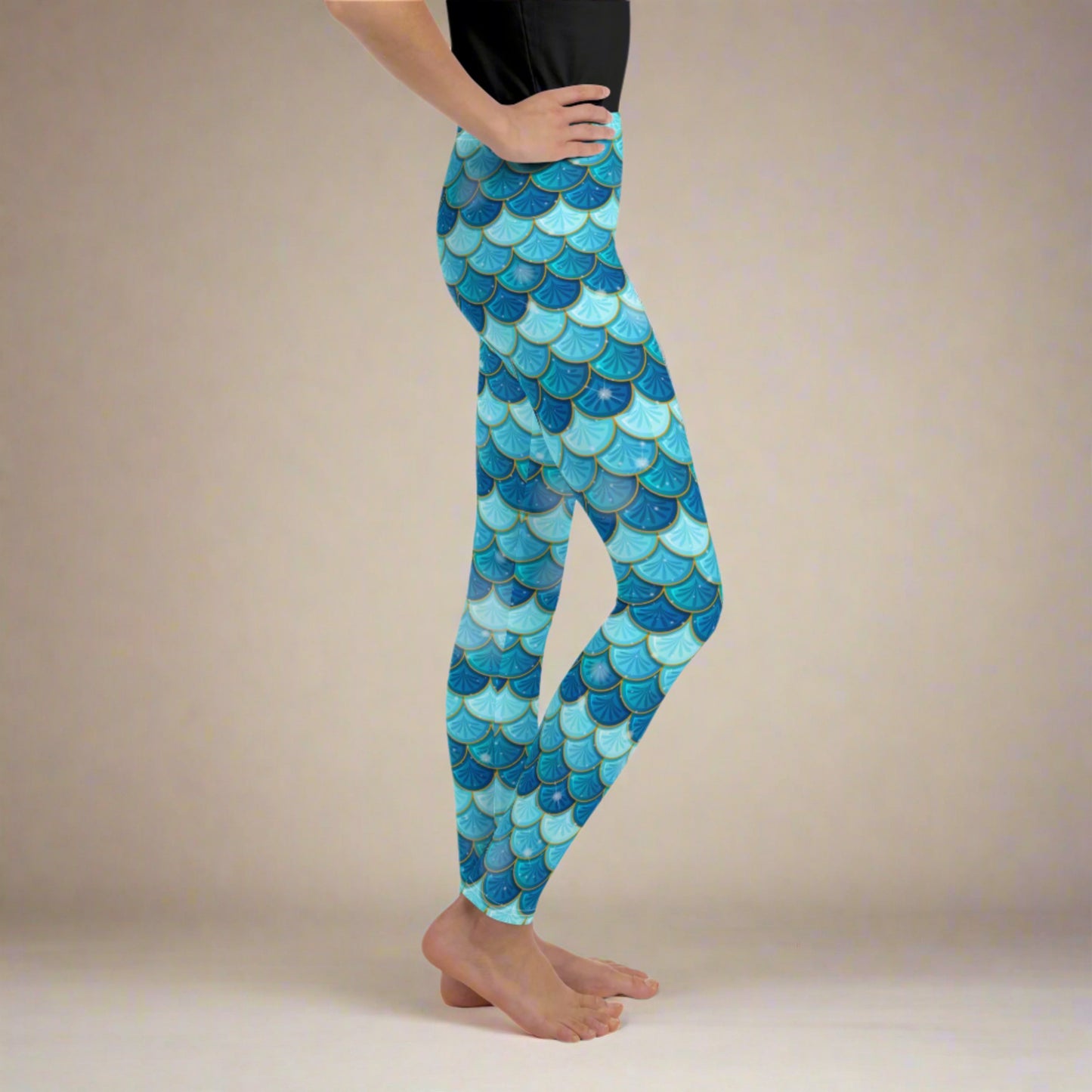 Image: Mermaid Youth Girls Leggings feature a stunning blue scale print, perfect for tweens and teens in sizes 8-20. Perfect for girls who love the mermaid aesthetic, by jaecrece