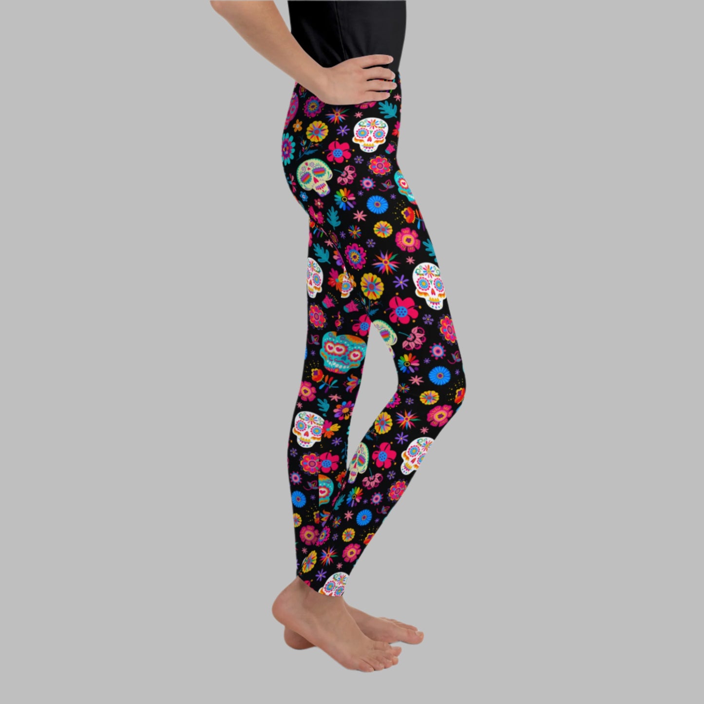 These Día de los Muertos youth leggings for girls and tweens, available in sizes 8–20, feature a festive sugar skull design perfect for cultural celebrations, fall school events, and Halloween. The soft, stretchy fabric offers comfort for active kids. Pair with our toddler and women’s leggings for a family matching Day of the Dead outfit. Great for parades, photo shoots, or Hispanic Heritage Month.