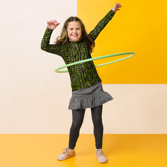 Youth rash guard with bold green reptile scale print, available in sizes 8–20. This long sleeve swim shirt is ideal for outdoor play, beach days, and summer vacations. Designed for costume fun, it works great for dinosaur, lizard, snake, or serpent outfits. Offers UPF 50+ protection, stretchy comfort, and all-over print style perfect for tweens who love animals, nature, or imaginative dress-up play in and out of the water.