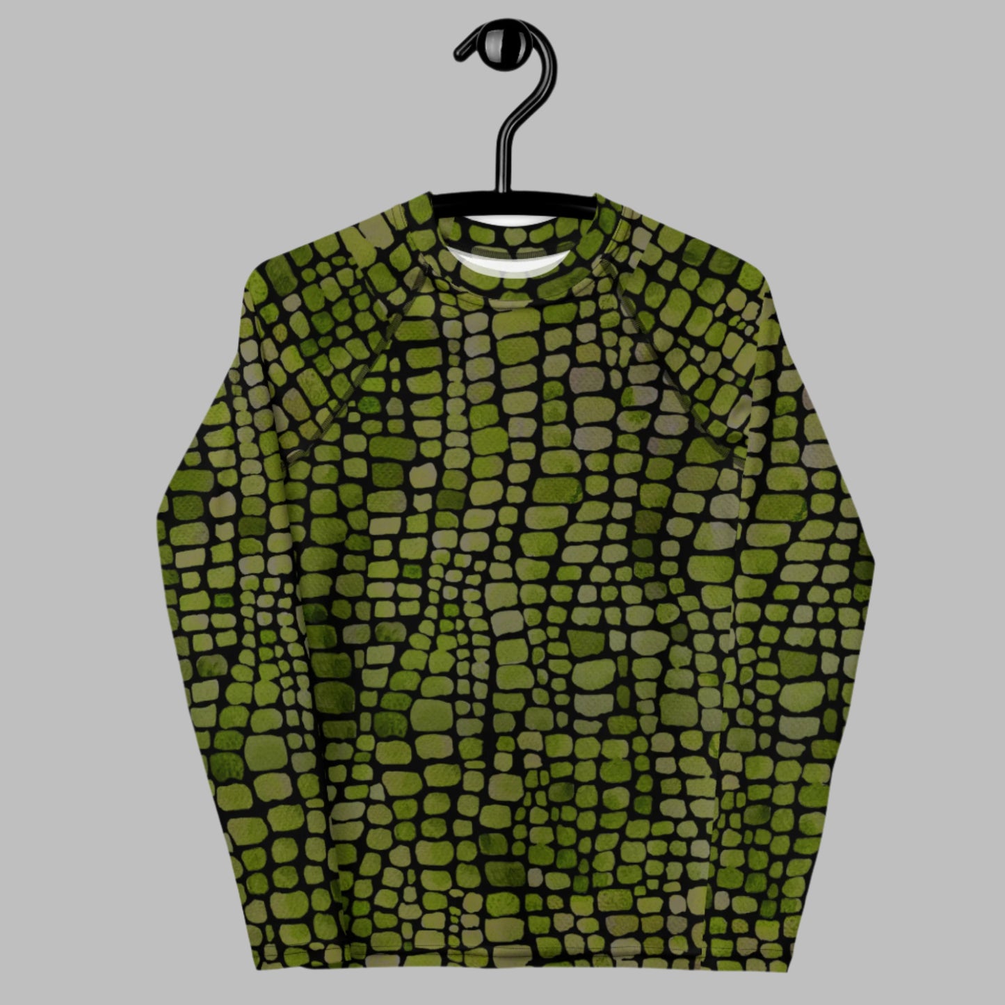 Youth rash guard for boys and girls in sizes 8–20 with an all-over green reptile scale print. Great for use as a costume top for lizards, snakes, or dinosaurs, or as sun-safe swimwear for summer outings. This long-sleeve shirt provides UPF 50+ protection and active comfort. Perfect for jungle birthday parties, pool play, or vacations. Ideal for tweens who enjoy bold prints and animal-inspired fashion.