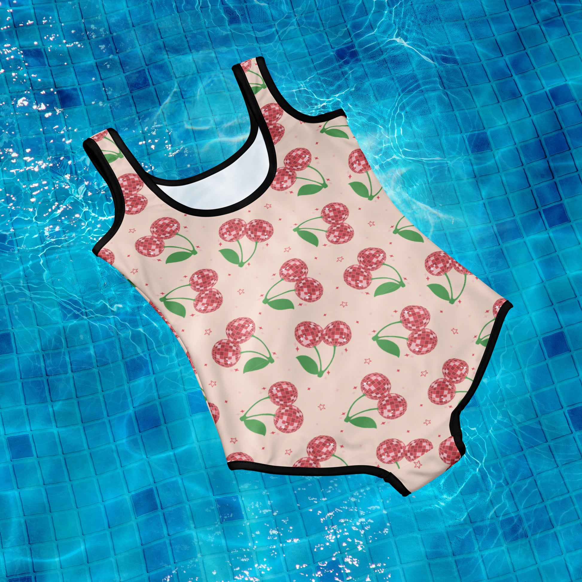 Image: Retro Cherries Youth Girls One Piece Bathing Suit. This fruit inspired swimsuit is a part of our Family Matching Swimwear Collection, and features a pink background with red disco ball cherries and stars, by jaecrece