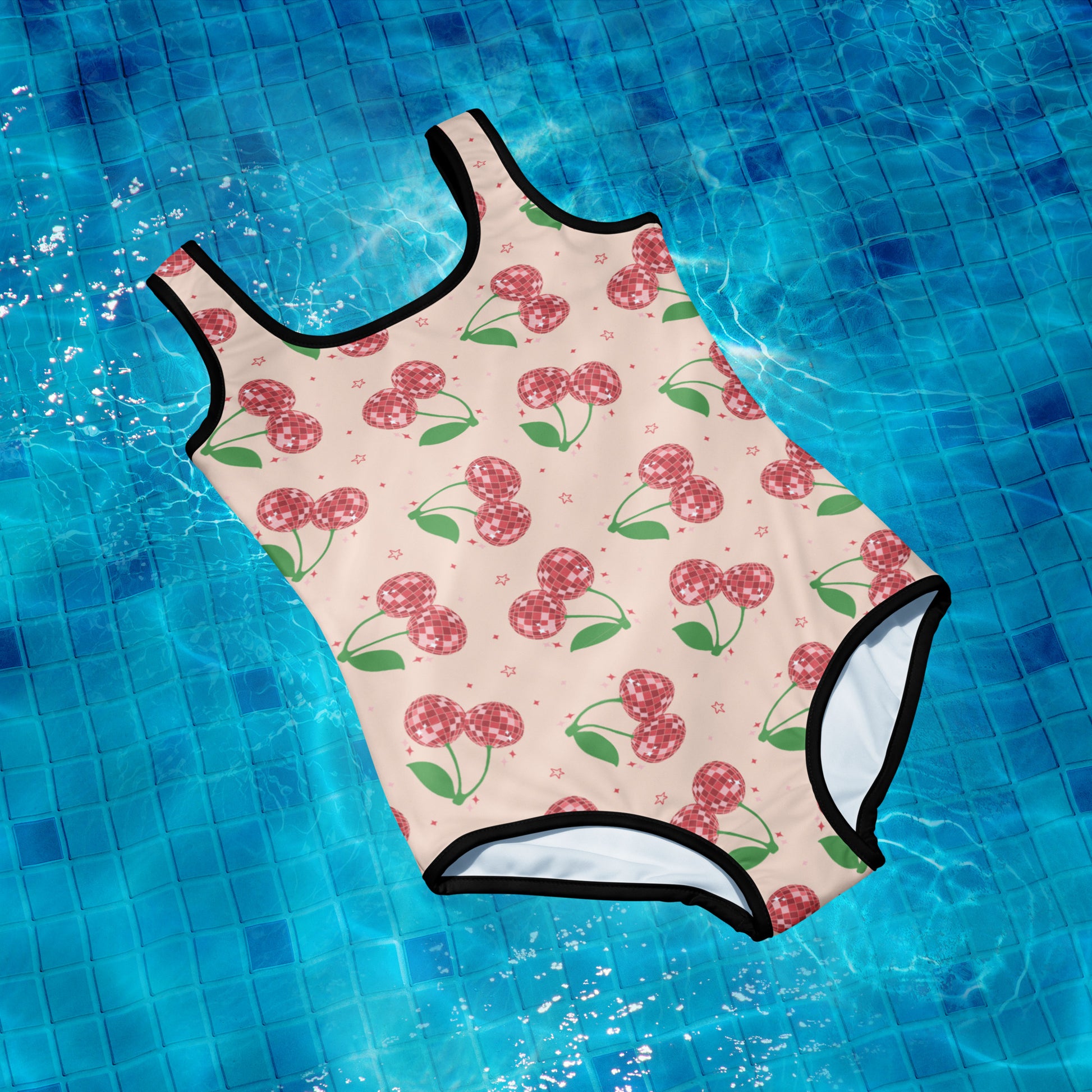 Image: Retro Cherries Youth Girls One Piece Bathing Suit. This fruit inspired swimsuit is a part of our Family Matching Swimwear Collection, and features a pink background with red disco ball cherries and stars, by jaecrece