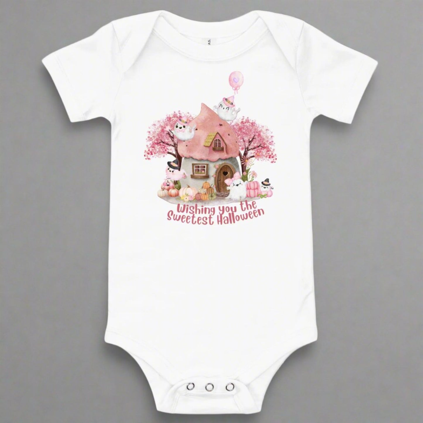Image: A soft pink Halloween baby bodysuit features a magical fairy tale cottage, smiling pink pumpkins, and friendly ghosts, ideal for baby's first spooky season photos and celebrations. Perfect for pastel Halloween themes, baby girl costumes, and sweet ghost baby gifts, this cozy one piece includes snaps for easy changing and all day comfort, by jaecrece.