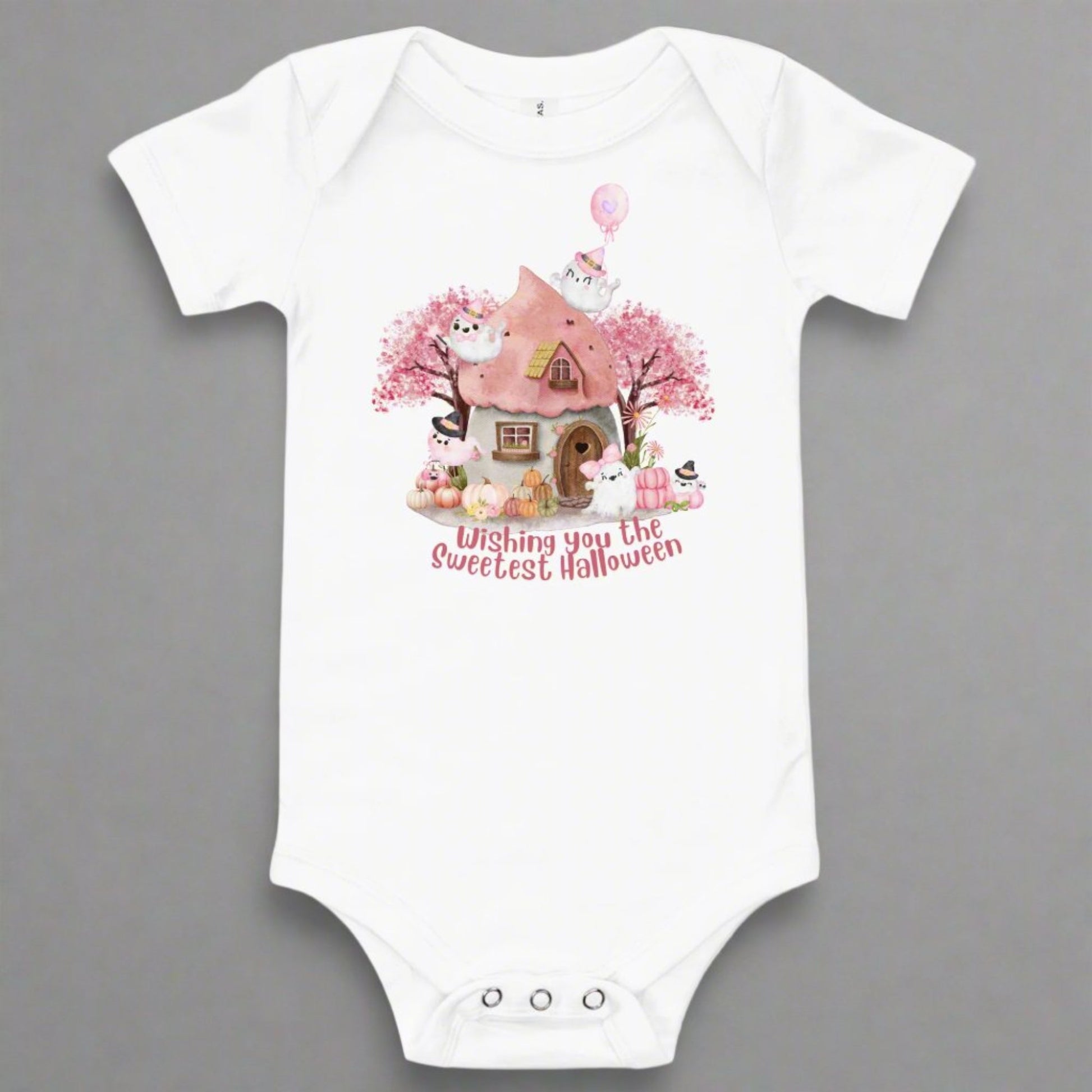 Image: A soft pink Halloween baby bodysuit features a magical fairy tale cottage, smiling pink pumpkins, and friendly ghosts, ideal for baby's first spooky season photos and celebrations. Perfect for pastel Halloween themes, baby girl costumes, and sweet ghost baby gifts, this cozy one piece includes snaps for easy changing and all day comfort, by jaecrece.