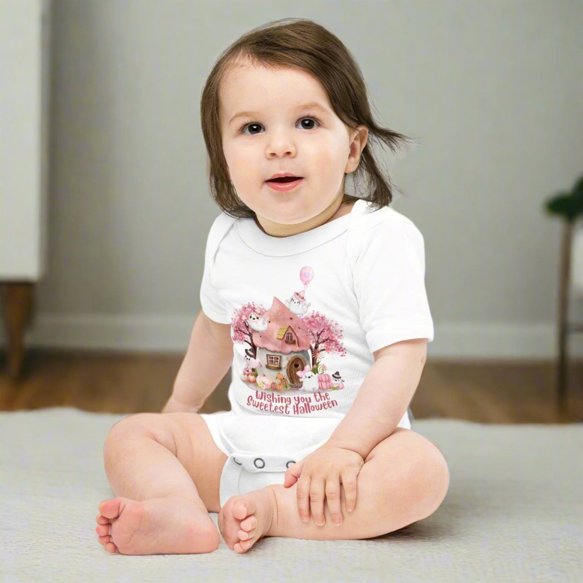 Image: This baby girl Halloween bodysuit in soft pink showcases a whimsical Halloween design with pink pumpkins, friendly ghosts, and a magical cottage scene. The perfect outfit for newborn fall pictures, baby's first trick-or-treat, or a sweet spooky gift for baby girls, offering comfort and cuteness all in one, by jaecrece.