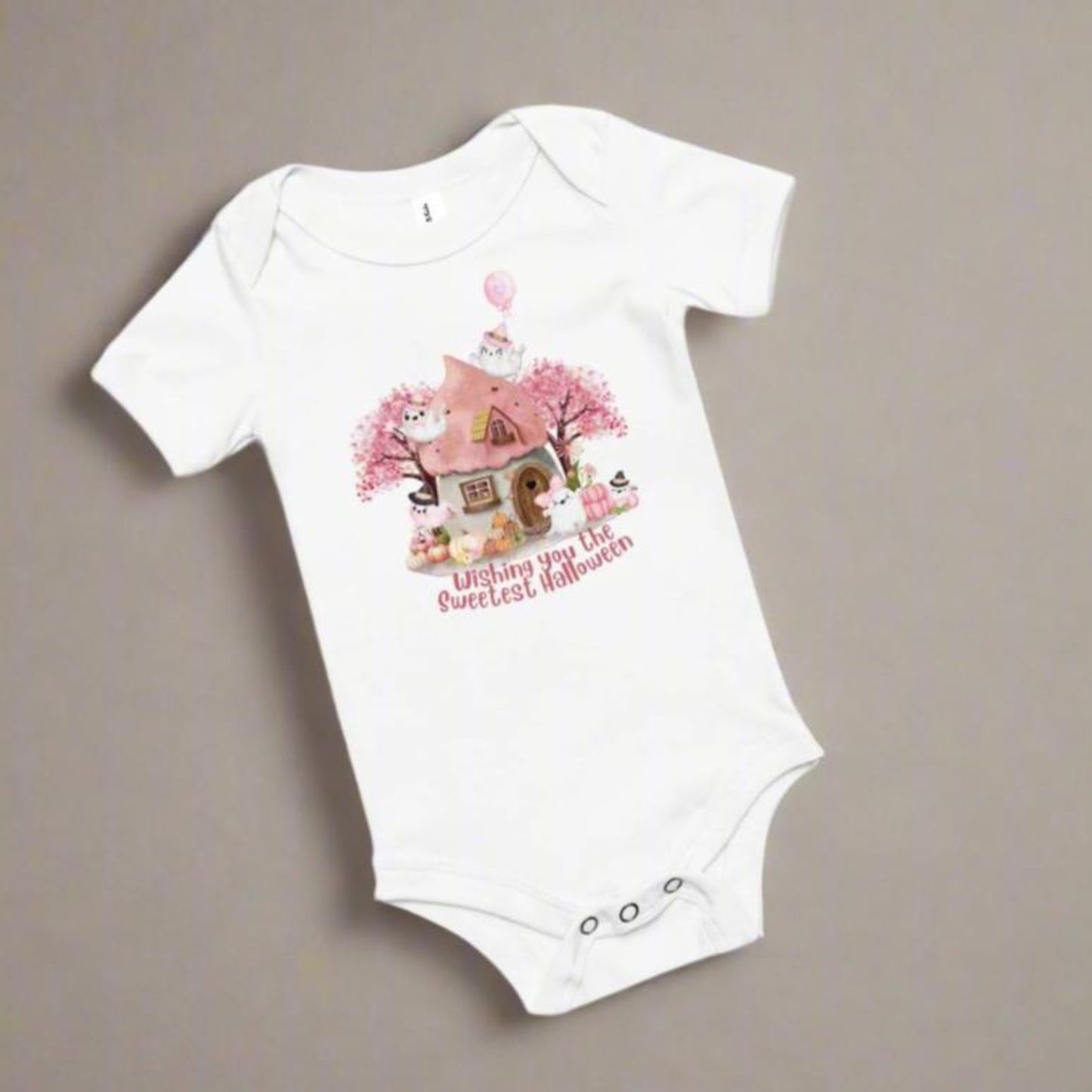 Image: This cozy Halloween baby bodysuit features a storybook-inspired design with pink pumpkins, cute ghost characters, and a soft autumn theme, great for baby's first fall holiday. Snap closures make diaper changes easy, while the pastel palette brings a touch of sweetness to spooky season, by jaecrece.
