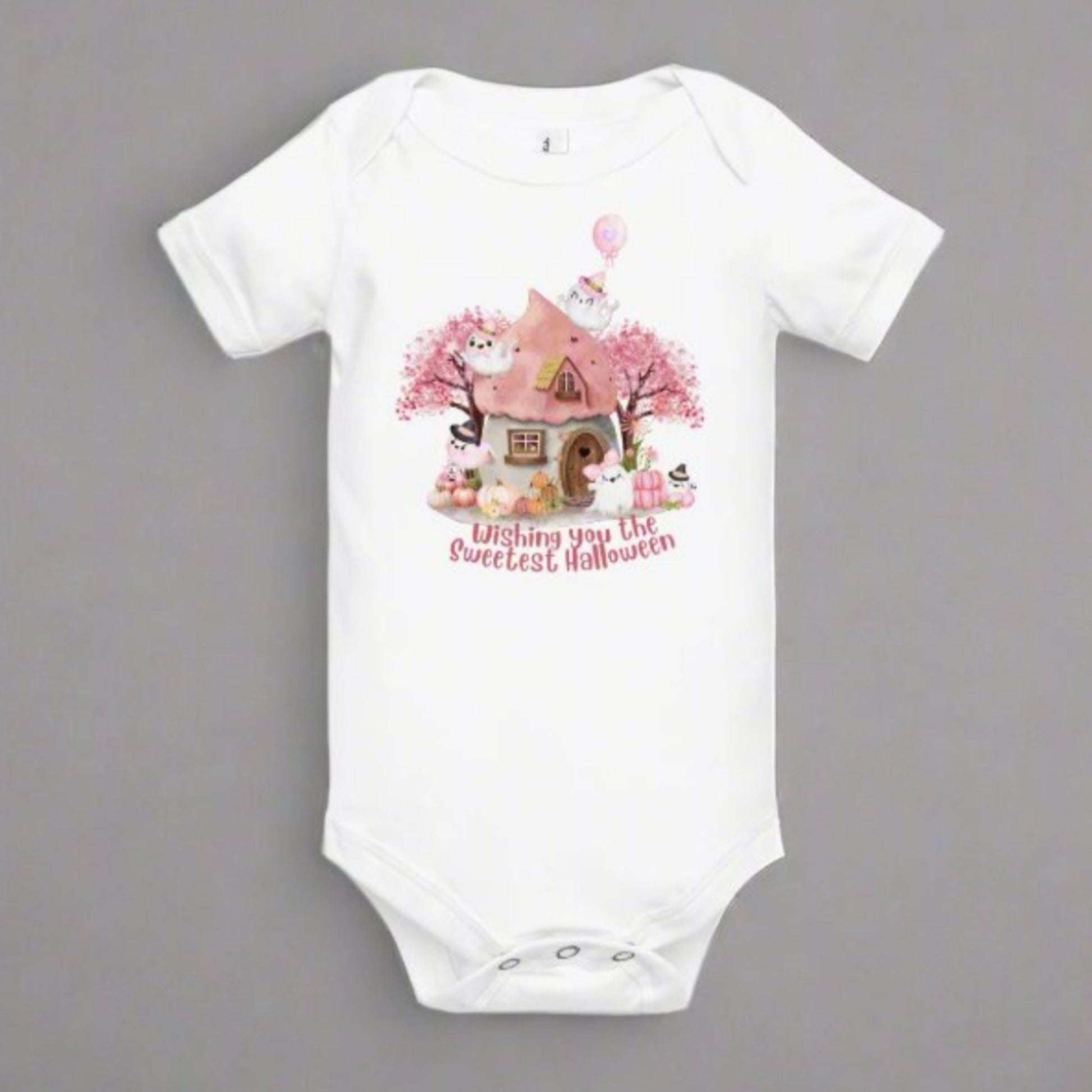Image: Dress your little pumpkin in this pink Halloween bodysuit with pastel ghosts, a fairy tale cottage, and soft spooky elements. A seasonal favorite for baby girls, this outfit is designed for baby's first Halloween celebrations, photo sessions, and sweet fall family outings, by jaecrece.