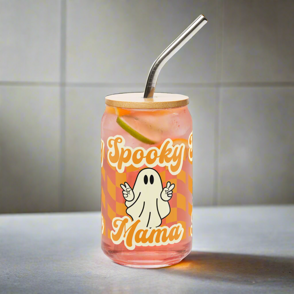 Cute Ghost Halloween Fall 16 oz Sipper Glass Funny Halloween Gift for Mom Spooky Mama Halloween Glass Coffee Cup, featuring a orange checkerboard design with a white ghost giving the peace sign and the text Spooky Mama in orange and white cursive bubble font by jaecrece.com