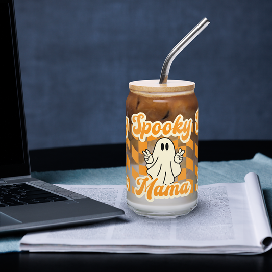 Cute Ghost Halloween Fall 16 oz Sipper Glass Funny Halloween Gift for Mom Spooky Mama Halloween Glass Coffee Cup, featuring a orange checkerboard design with a white ghost giving the peace sign and the text Spooky Mama in orange and white cursive bubble font by jaecrece.com