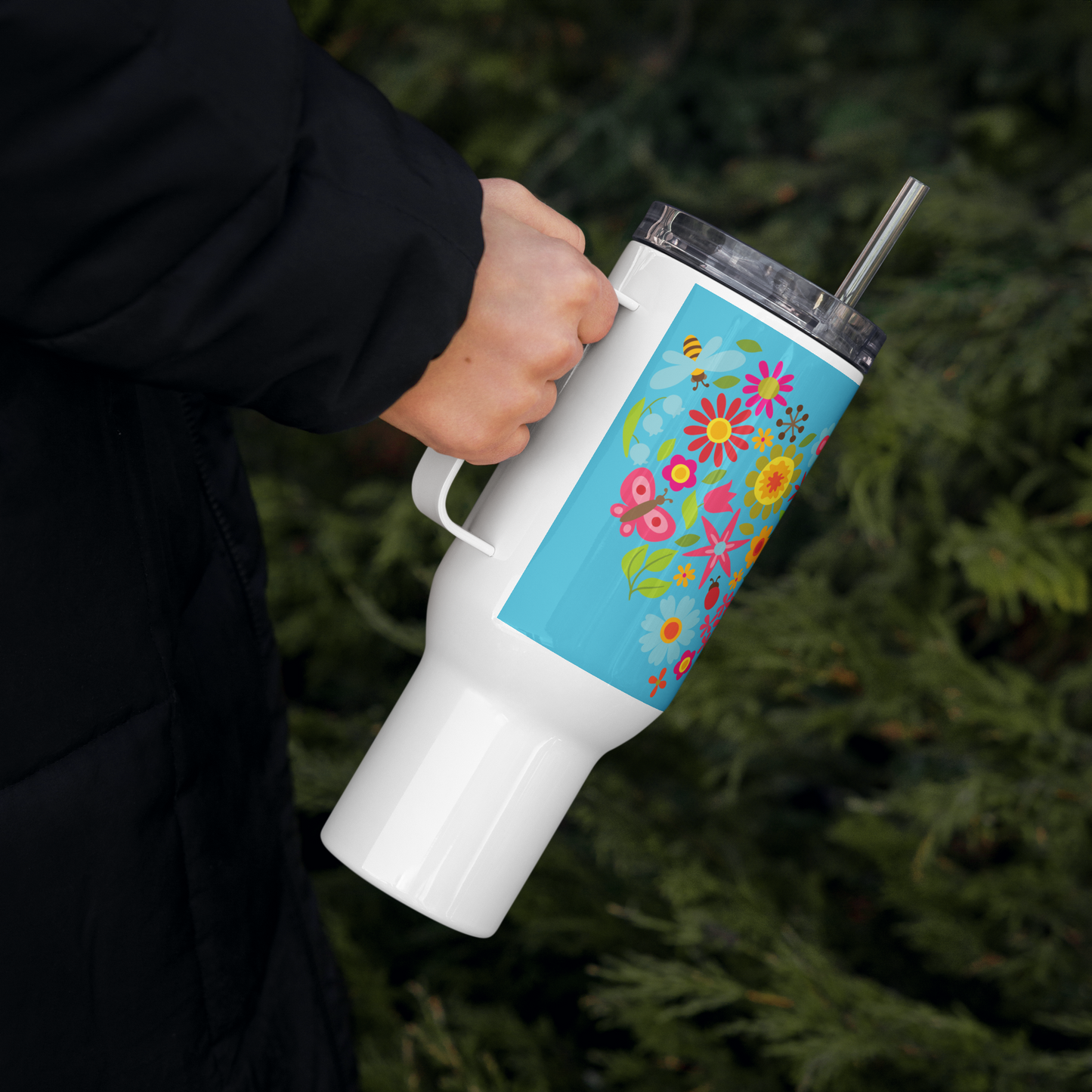 Image: A floral-themed 40oz tumbler with a handle, featuring a lively sunflower and butterfly print. This travel cup comes with a lid and straw, making it perfect for road trips, workouts, or cozy mornings. The bright and cheerful botanical design is great for gardeners, outdoor lovers, or those who enjoy sipping their drinks in style. A unique and practical gift idea, by jaecrece.