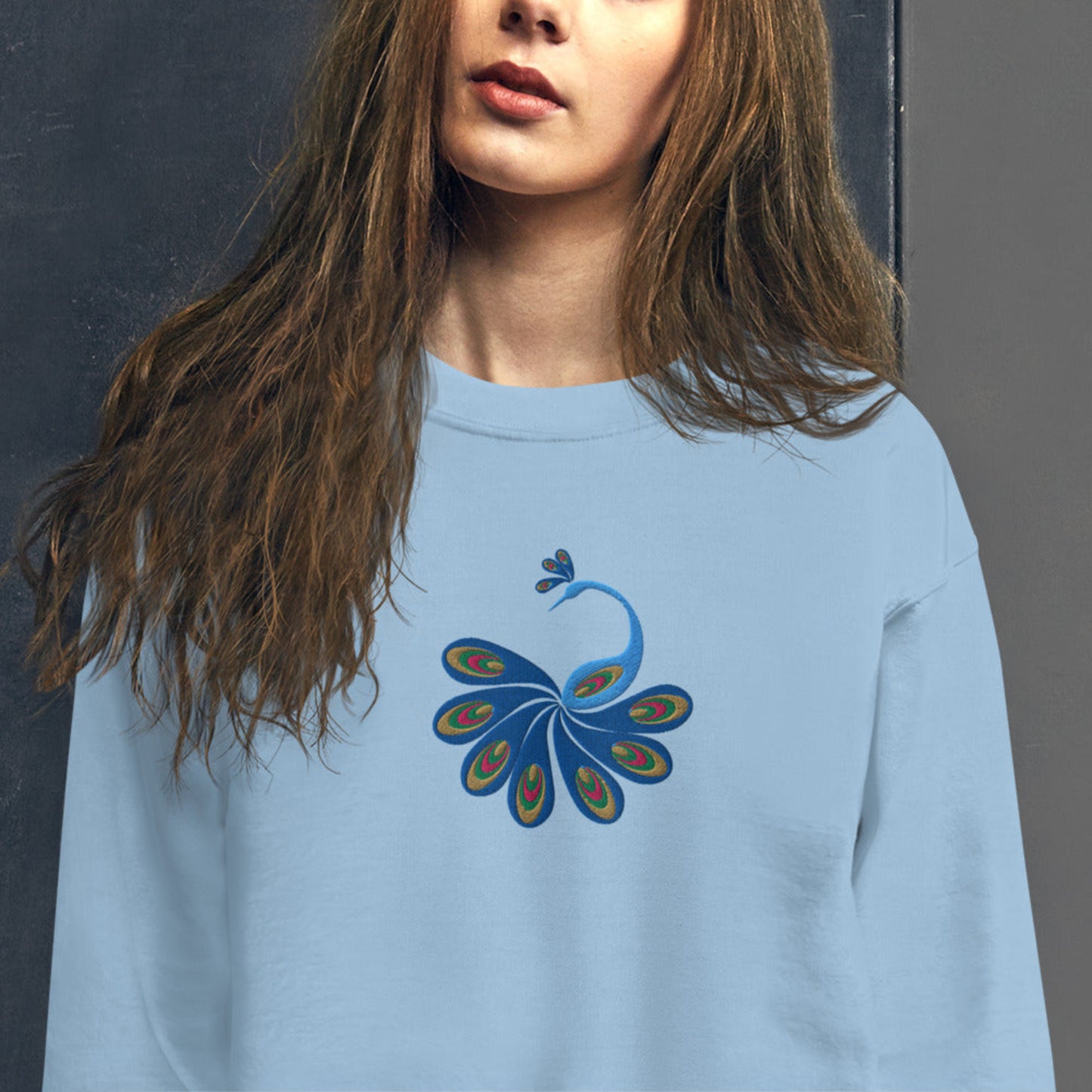 Image: Our women’s peacock embroidered sweatshirt pairs vibrant feathered beauty with wearable comfort, making it a cozy yet bold piece for any season. With detailed stitching and a flattering fit, this pullover is perfect for chilly days, casual outings, or as a gift for anyone who loves animals, birds, and cottagecore-inspired apparel. Add a touch of whimsy and warmth to your wardrobe with this artistic design, by jaecrece.