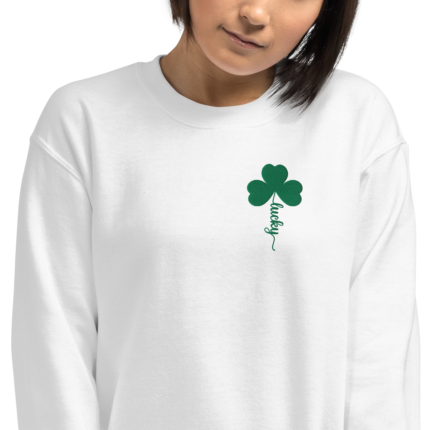 Image: St Patricks Day Emboidered Shamrock Lucky Women's Sweatshirt. This white crewneck pullover has embroidered green four leaf clover, and stem of the clover spells Lucky. This St. Pattys Day pullover sweater is also available in childrens sizes, for family matching opportunities, by jaecrece