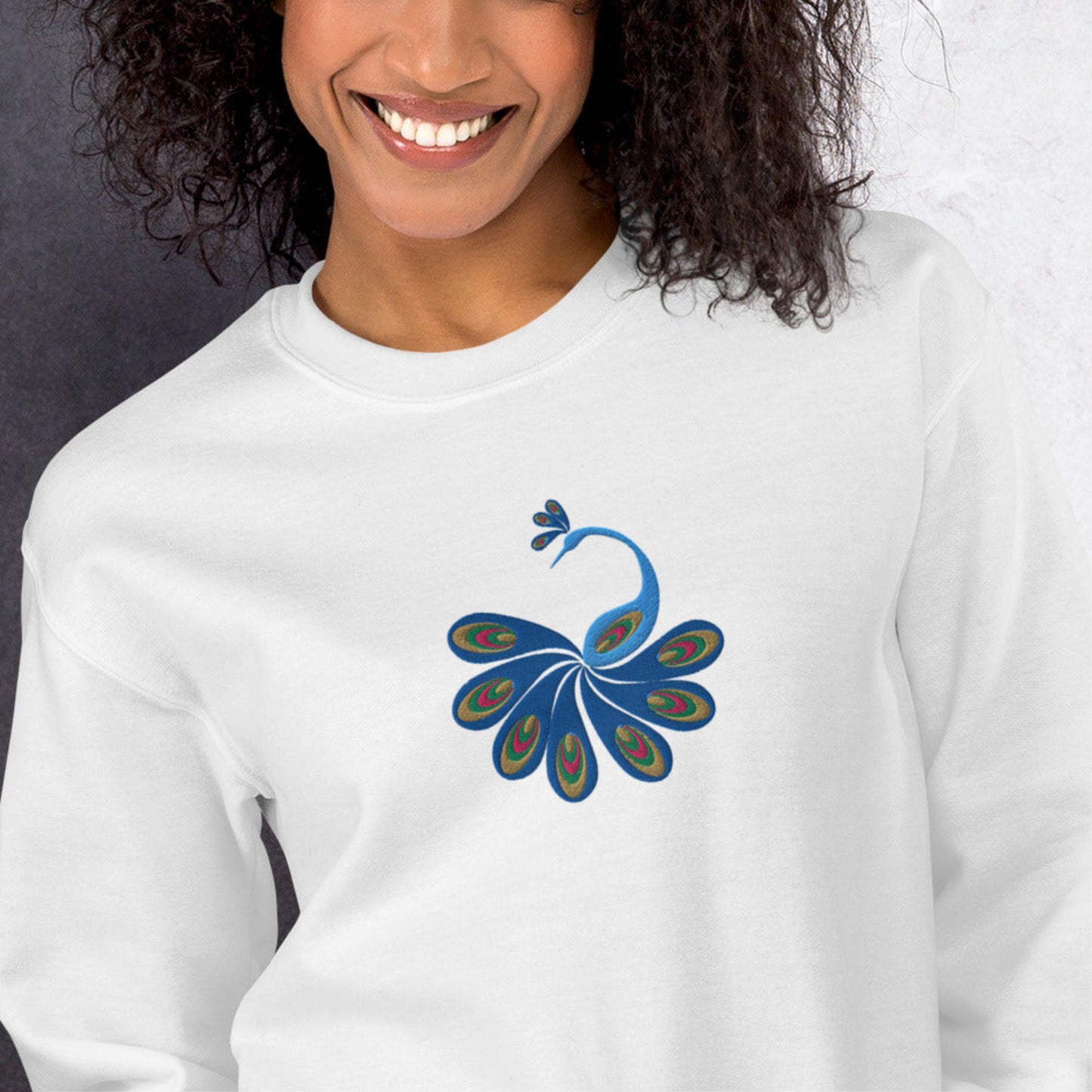Image: Cozy up in this bohemian embroidered sweatshirt for women, featuring a stunning peacock design. Perfect for transitional seasons, this soft pullover brings together artistic flair and wearable comfort. Ideal for anyone drawn to detailed embroidery, wildlife motifs, or the cottagecore aesthetic, this embroidered top adds whimsical beauty to any outfit and makes a thoughtful gift for bird lovers or creatives, by jaecrece.