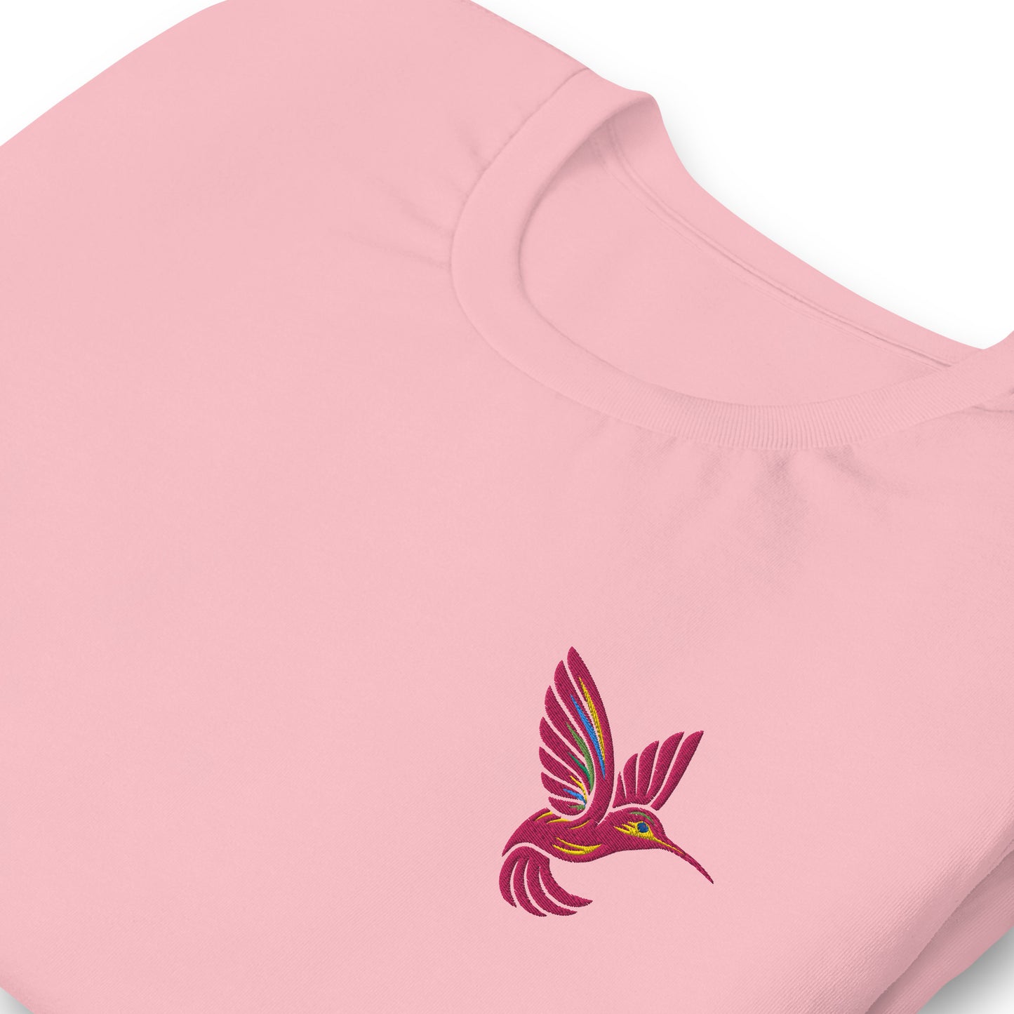 Close-up of the embroidered pink hummingbird stitched onto the chest of a white cotton shirt. This breathable, lightweight tee is designed for nature lovers and birdwatchers who appreciate quiet elegance. Available in sizes XS–5XL and five soft colors, it’s a thoughtful gift for moms, friends, or anyone who enjoys minimalist embroidered fashion and sustainable wardrobe staples.