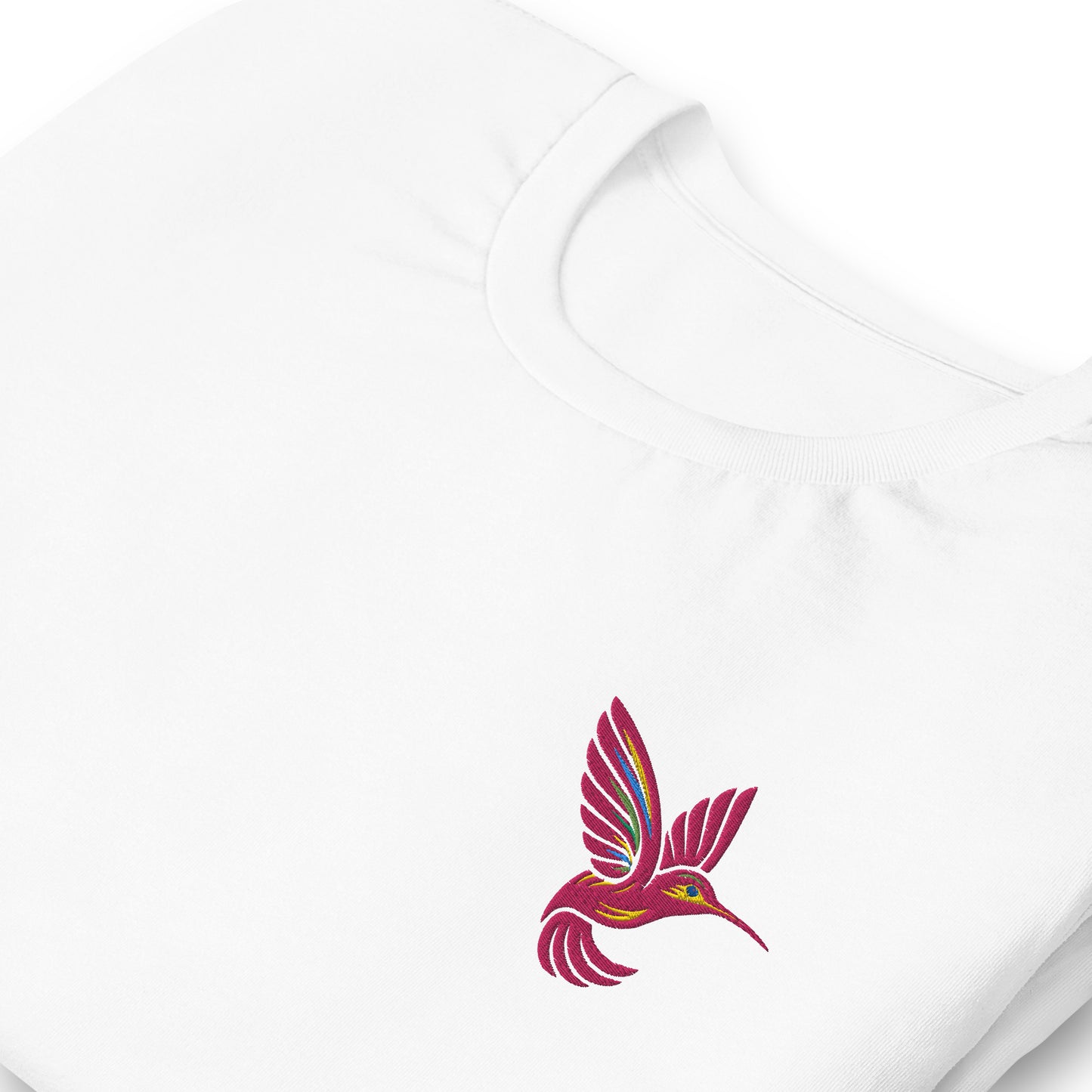 Hummingbird embroidered t-shirt in white, laid flat to highlight the intricate stitching on the chest. This unisex cotton tee is breathable, soft, and pre-shrunk, making it ideal for gifting or everyday wear. Great for birdwatchers, garden enthusiasts, and fans of embroidered fashion in five colors and inclusive sizing up to 5XL.