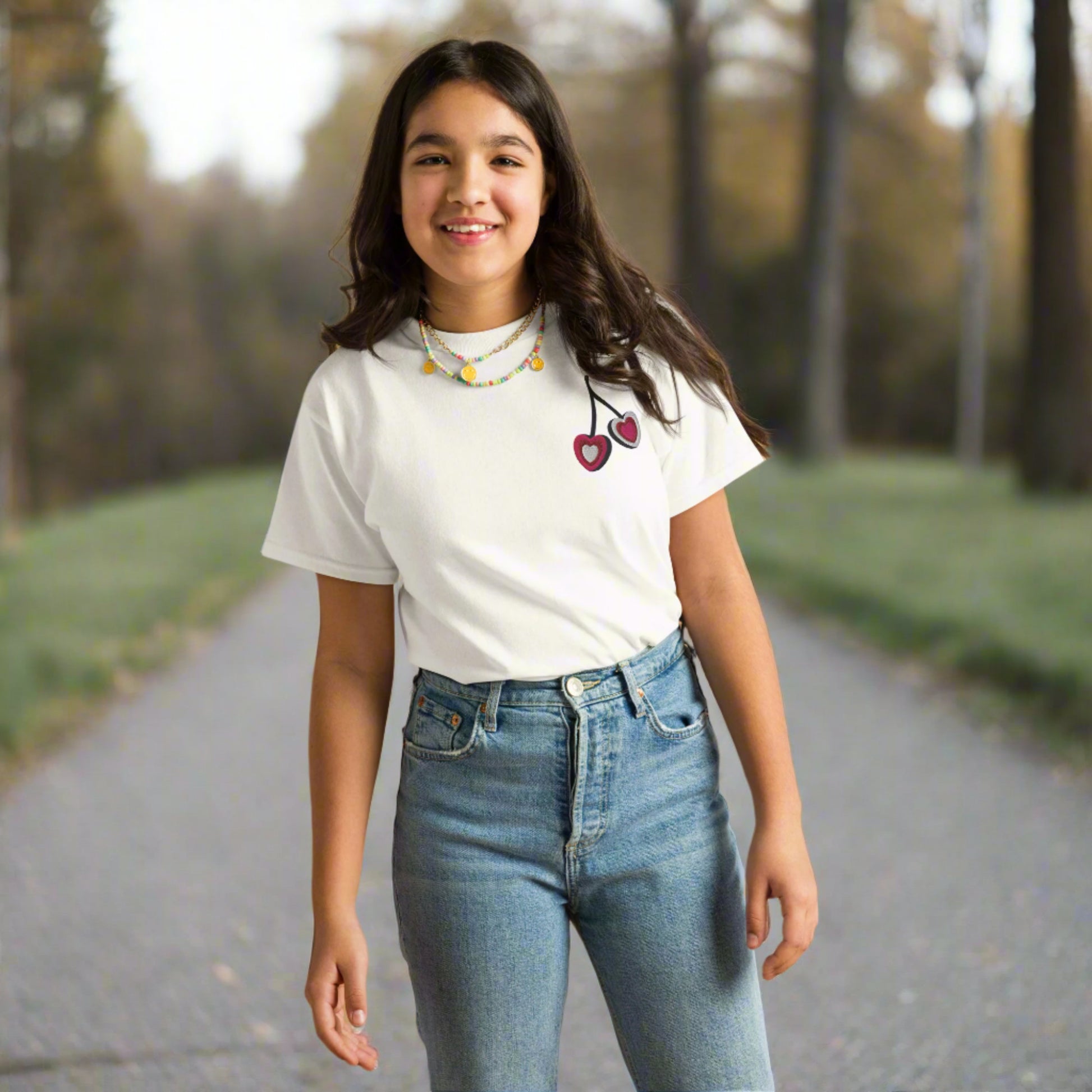 Image: Cherry Embroidery Shirt for Girls. This Valentines Day crewneck tee features two embroidered cherries on the left chest in red, pink and white with black stems. Great gift for tweens and toddlers who love the cherrycore aesthetic, by jaecrece