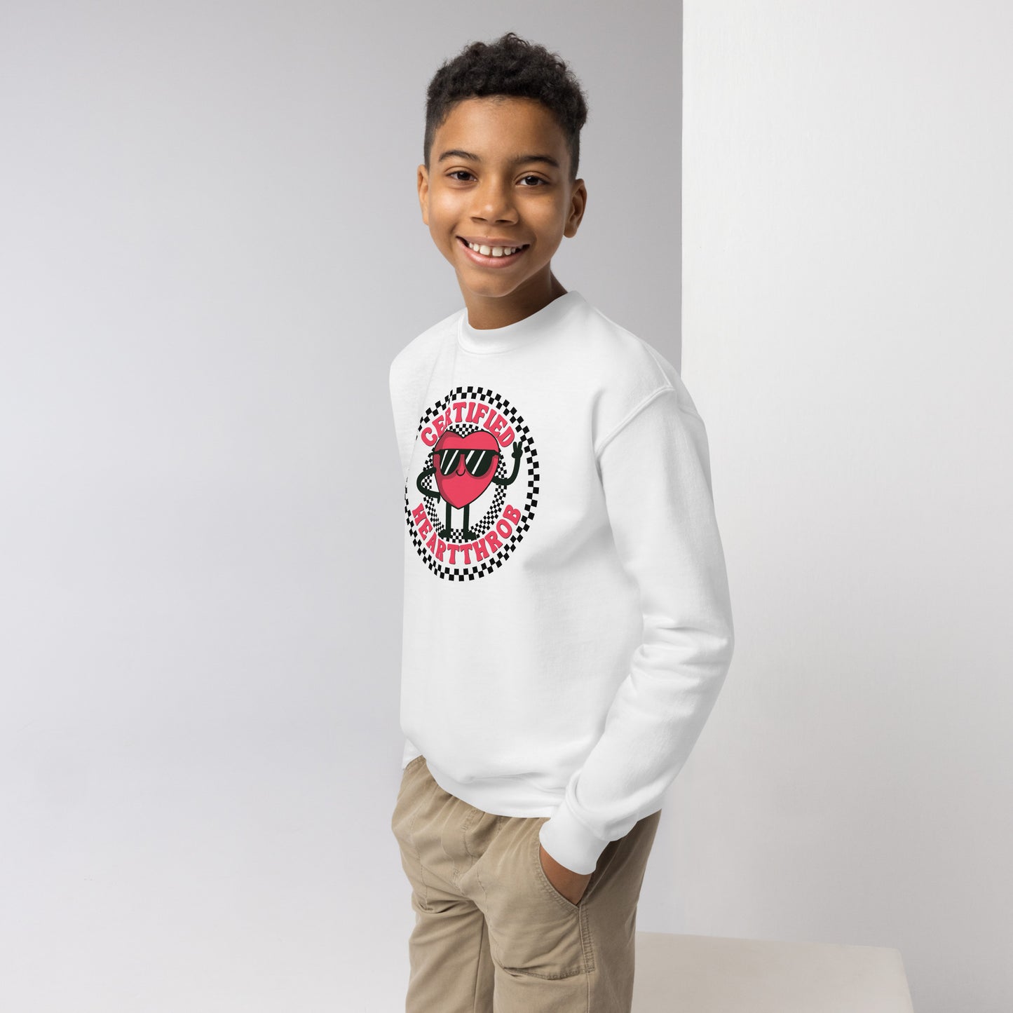 Image: Certified Heartthrob Sweatshirt. This Valentines Day sweater for boys or girls is available in white or gray. It features a checker pattern ring, with a cartoon heart man wearing sunglasses, with the text Certified Heartthrob, by jaecrece