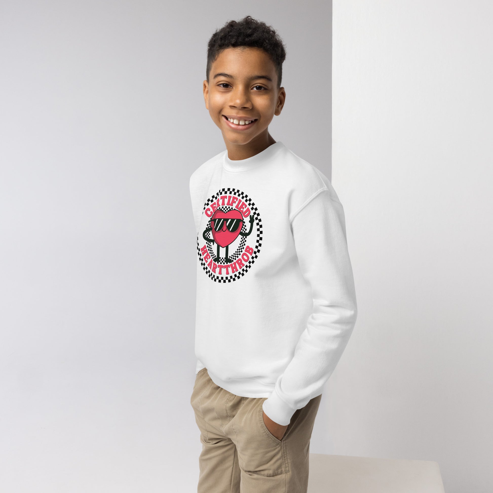 Image: Certified Heartthrob Sweatshirt. This Valentines Day sweater for boys or girls is available in white or gray. It features a checker pattern ring, with a cartoon heart man wearing sunglasses, with the text Certified Heartthrob, by jaecrece
