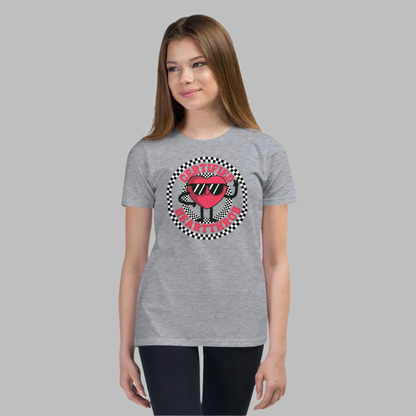 Image: Certified Heartthrob Tshirt. This Valentines Day tee for boys or girls is available in white or gray. It features a checker pattern ring, with a cartoon heart man wearing sunglasses, with the text Certified Heartthrob, by jaecrece