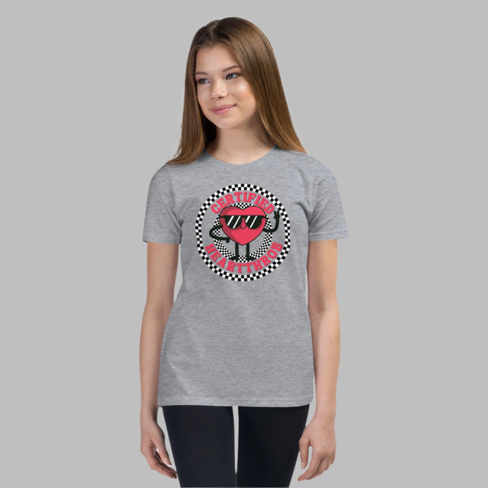 Image: Certified Heartthrob Tshirt. This Valentines Day tee for boys or girls is available in white or gray. It features a checker pattern ring, with a cartoon heart man wearing sunglasses, with the text Certified Heartthrob, by jaecrece