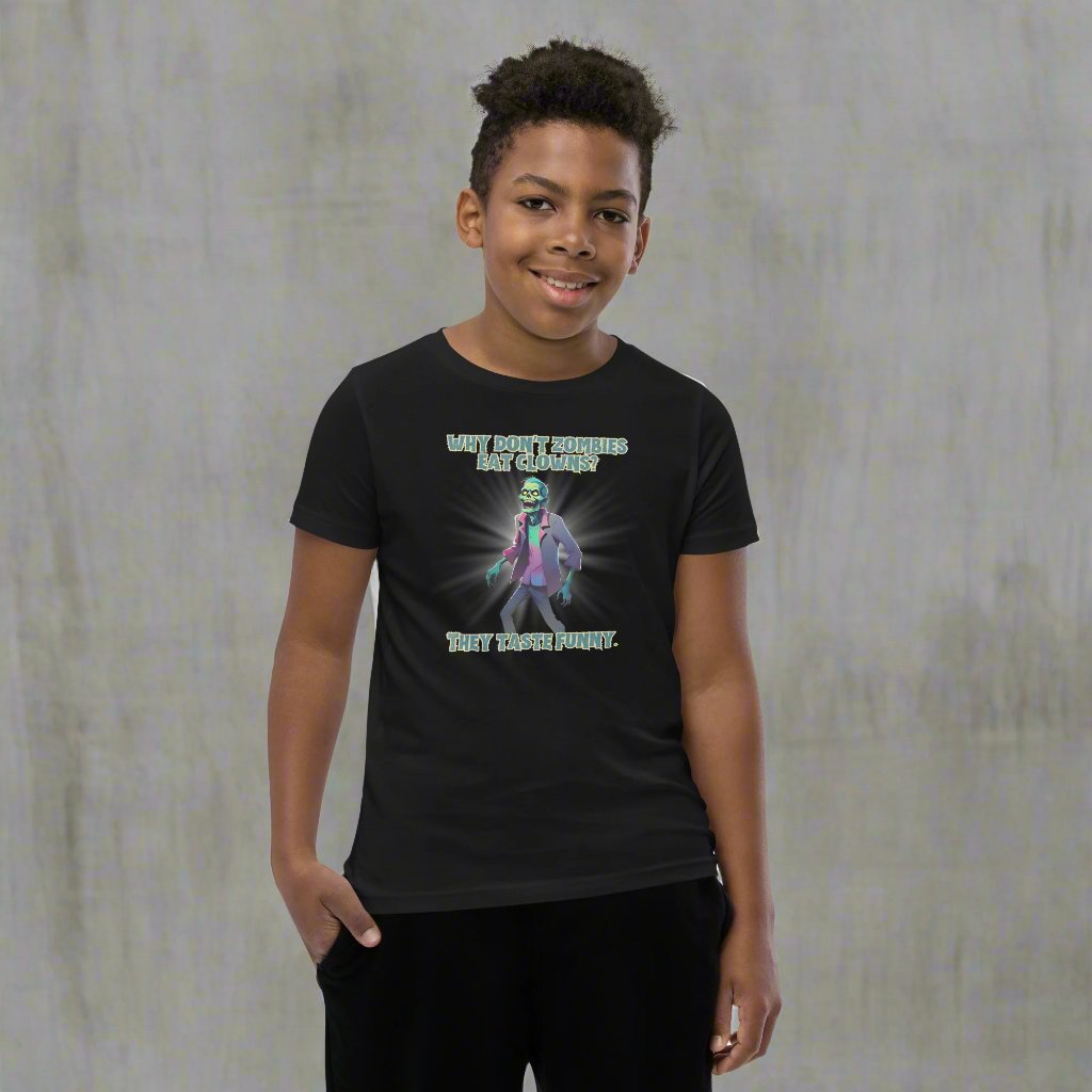 Halloween Zombie Joke Kids T-Shirt. This is a black tee with a picture of a laughing cartoon zombie. The text reads "Why don't zombies eat clowns? They taste funny", by jaecrece.com