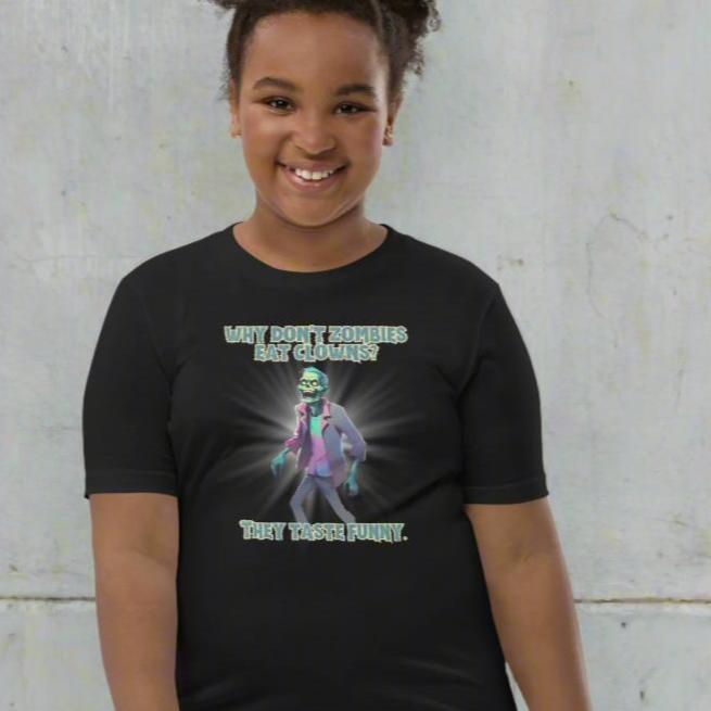 Halloween Zombie Joke Kids T-Shirt. This is a black tee with a picture of a laughing cartoon zombie. The text reads "Why don't zombies eat clowns? They taste funny", by jaecrece.com