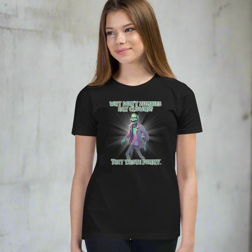 Halloween Zombie Joke Kids T-Shirt. This is a black tee with a picture of a laughing cartoon zombie. The text reads "Why don't zombies eat clowns? They taste funny", by jaecrece.com